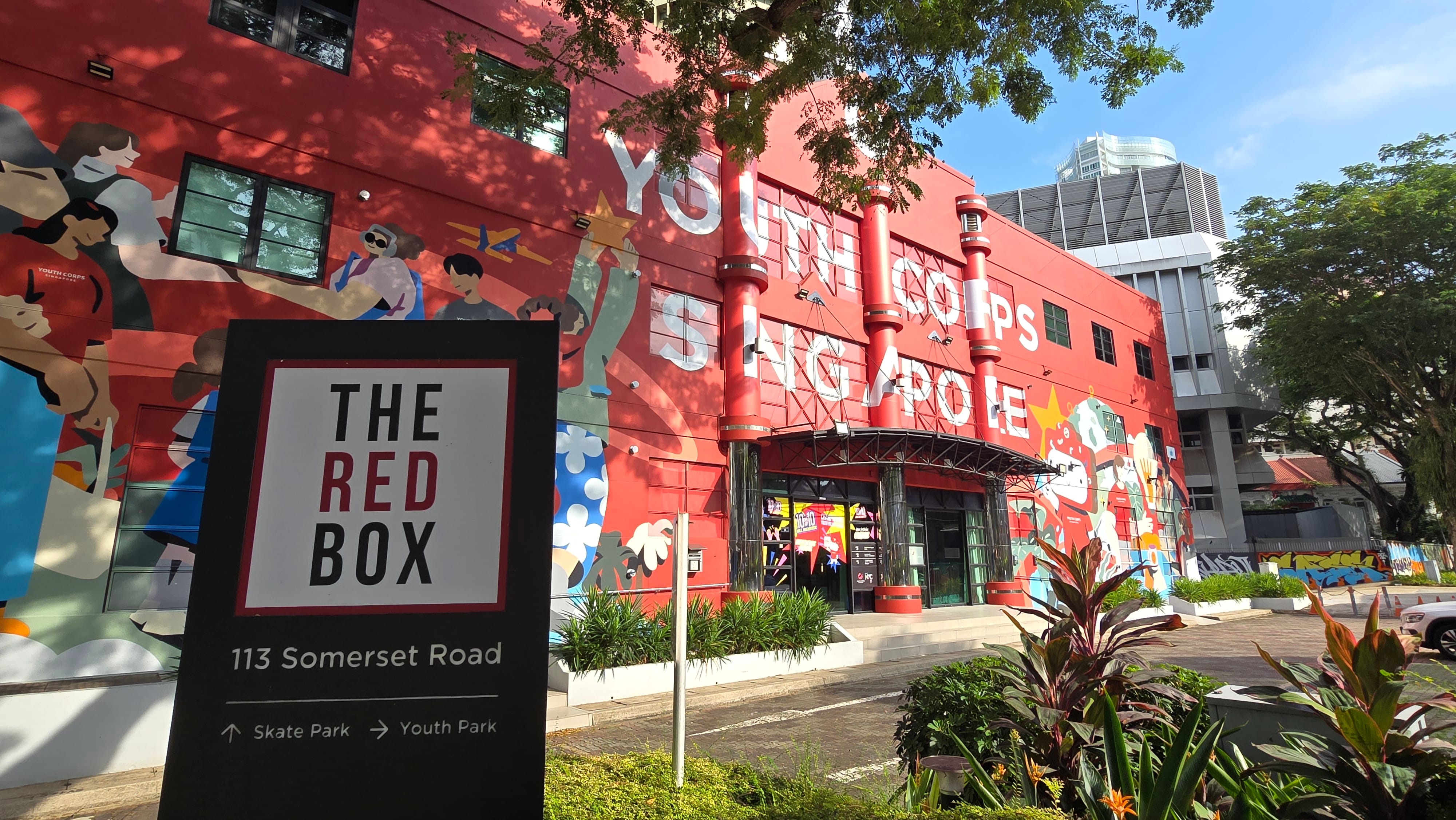 Entrance of The Red Box with sign pointing to Youth Park and Skate Park at Somerset