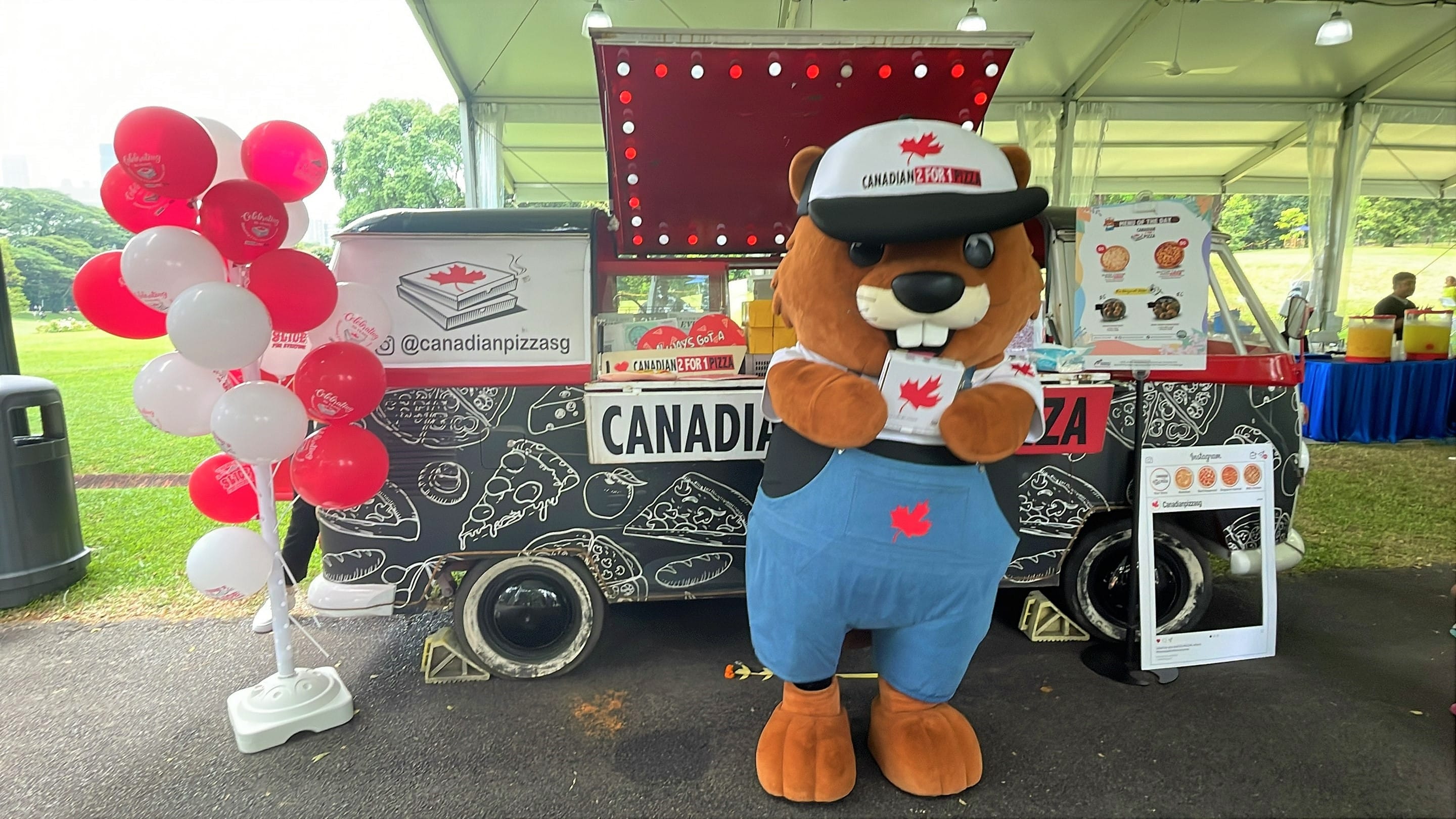 Canadian Pizza mascot in front of their kiosk