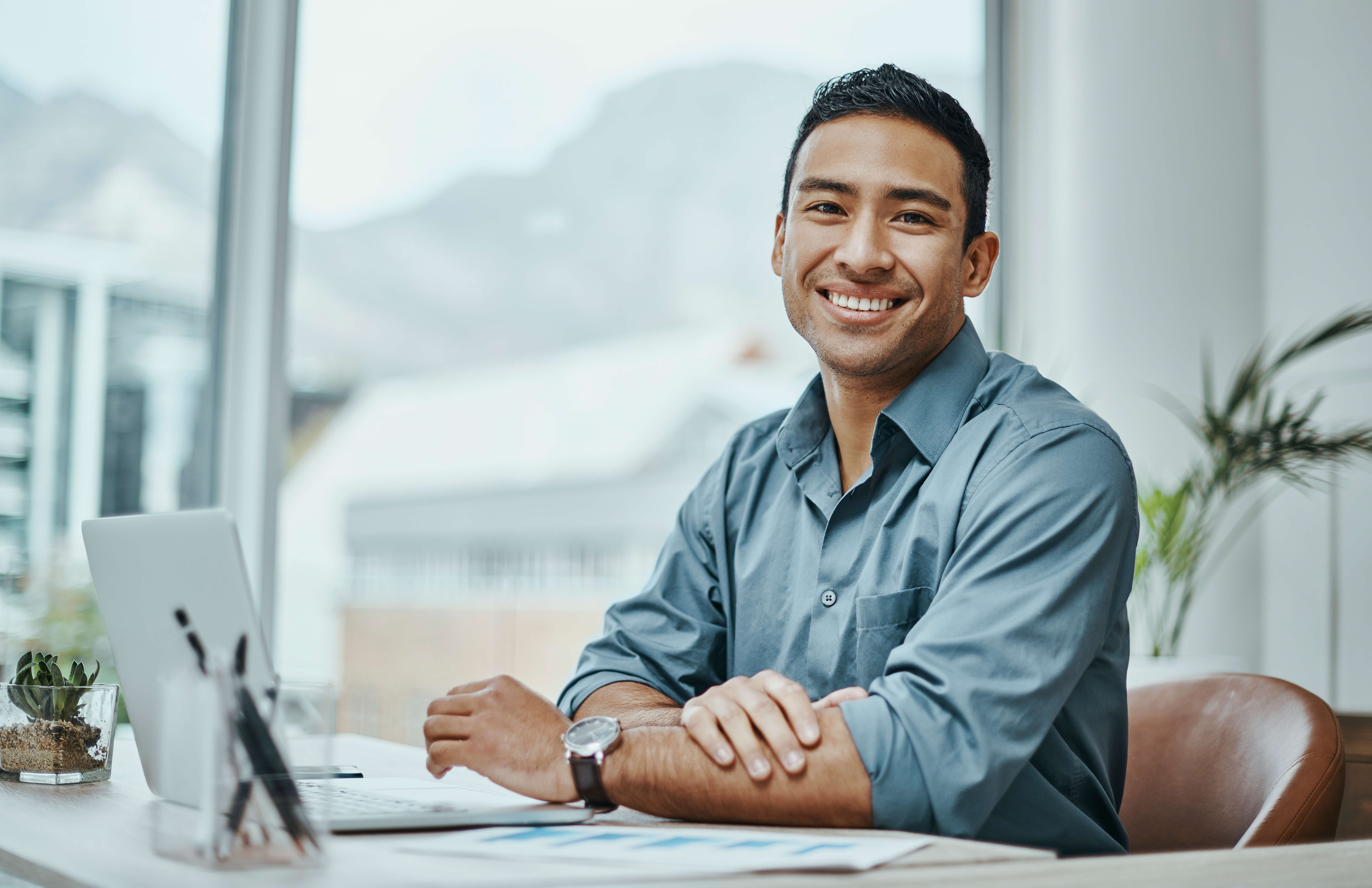 A man sitting at his desk feeling energised and inspired.
