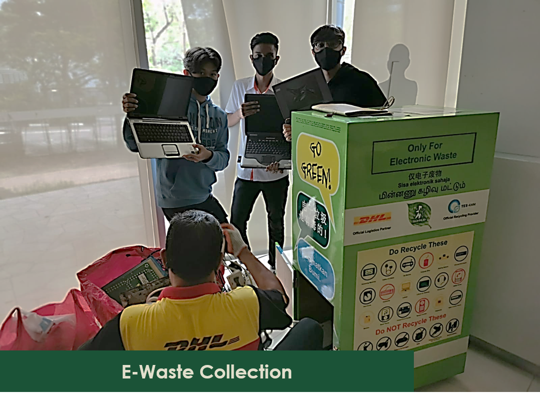 Three masked people hold laptops next to a DHL e-waste collection bin. DHL worker in yellow moves bags.