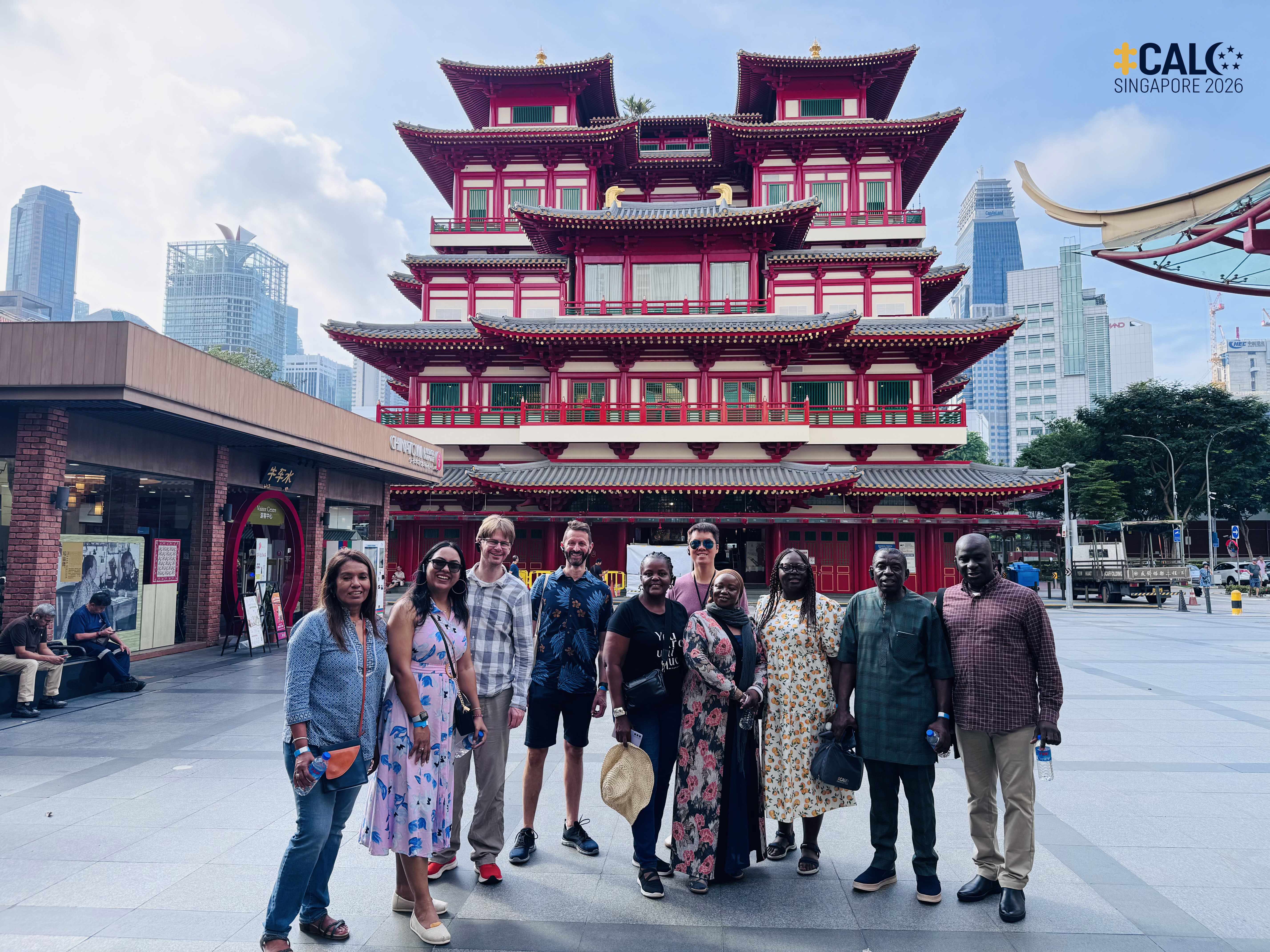 Conference delegates pose for a group photo in front of the Buddha Tooth Relic Temple in Chinatown, Singapore, on 18 July 2026.