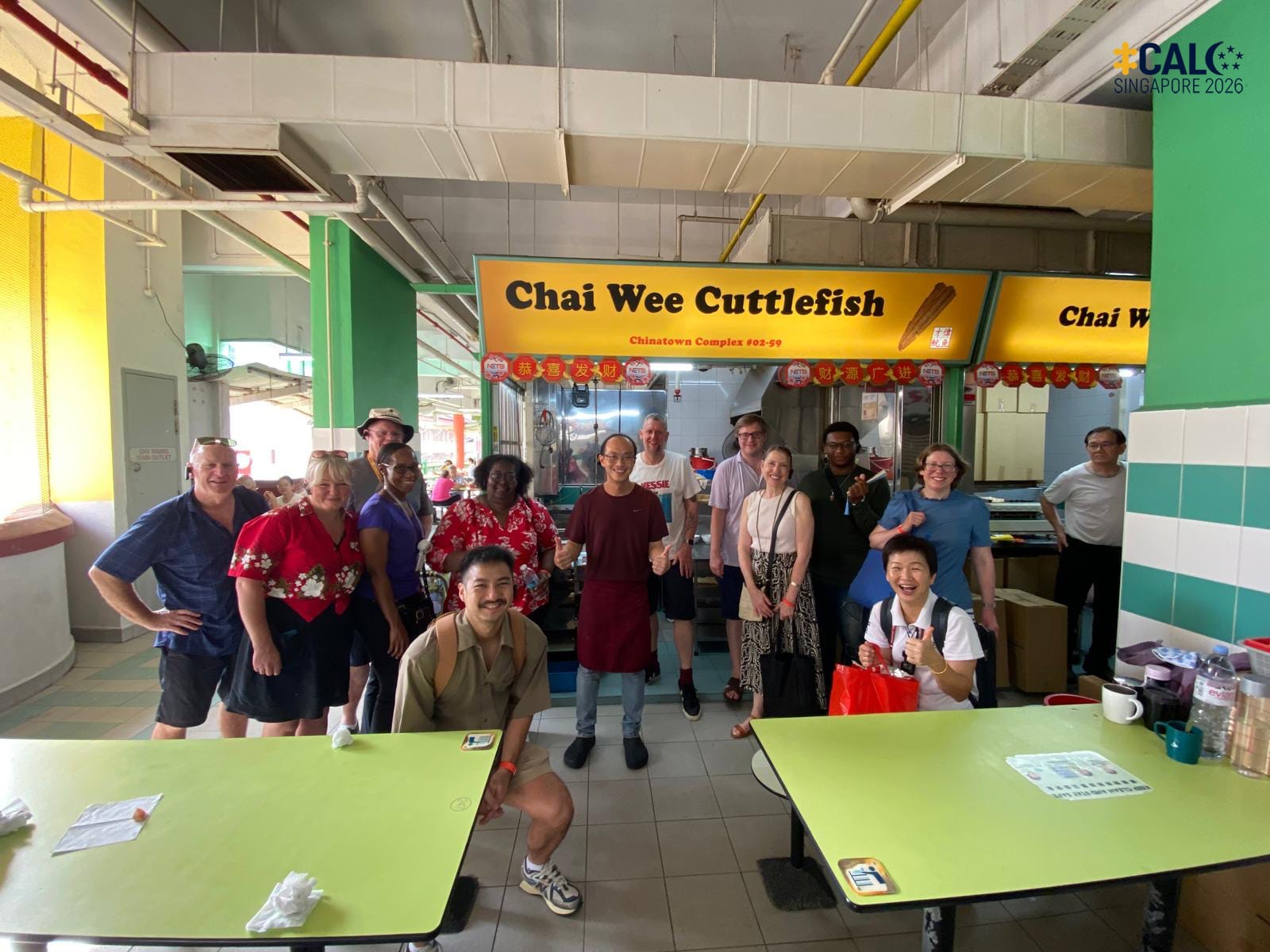 Conference delegates pose for a group photo at Chinatown Complex Market and Food Centre, Singapore, on 18 July 2026.