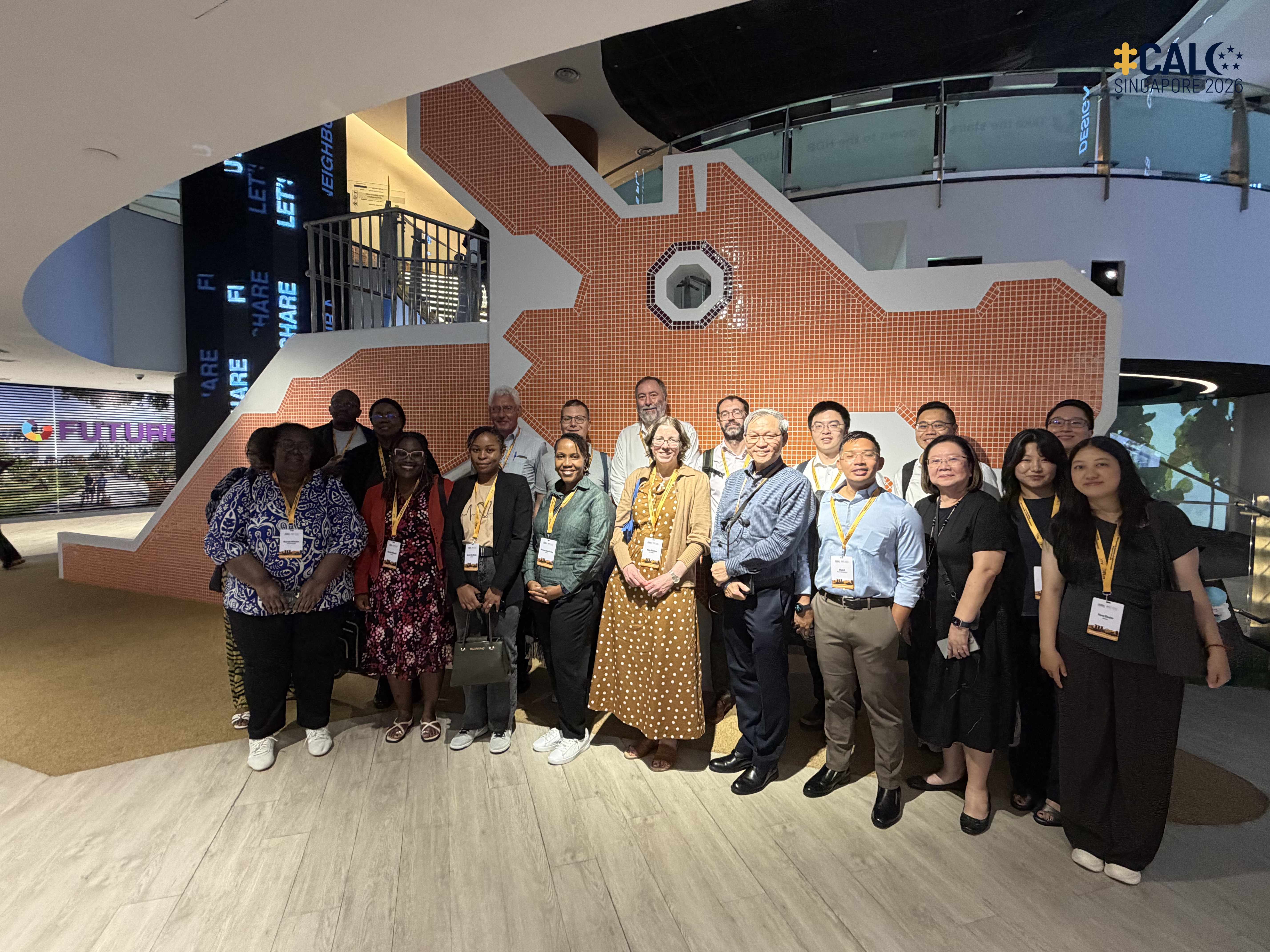 Conference delegates pose for a group photo in front of a replica of the Dragon Playground during a visit to HDB Hub, Singapore, on 17 July 2026.