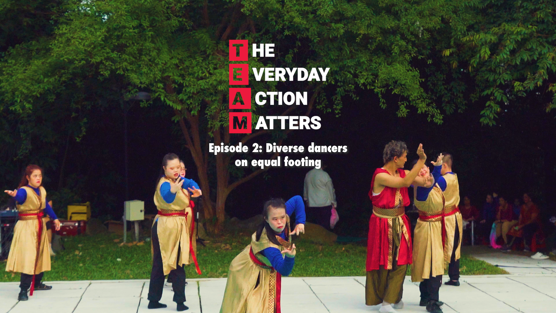 Thumbnail of video - dancers with down syndrome on a stage in a park.