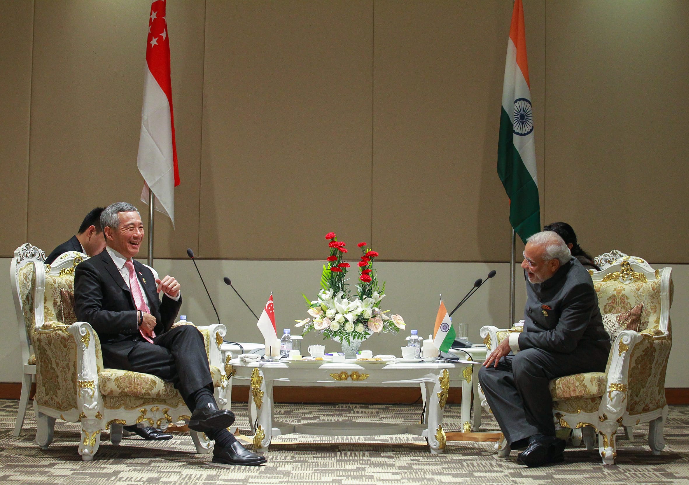 Lee Hsien Loong and Narendra Modi seated at a table with Singapore and India flags.