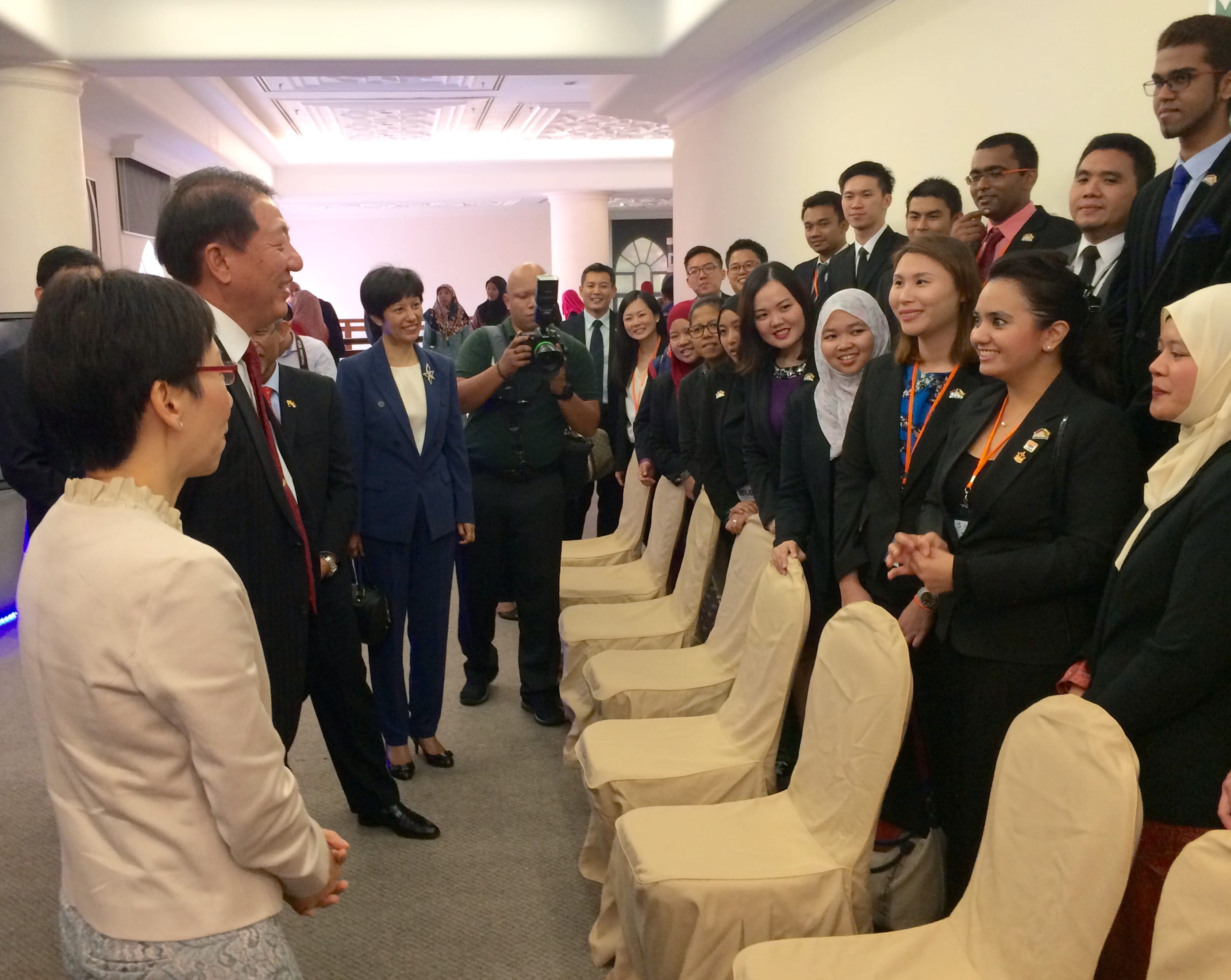 Group of people in business attire posing for a photograph.