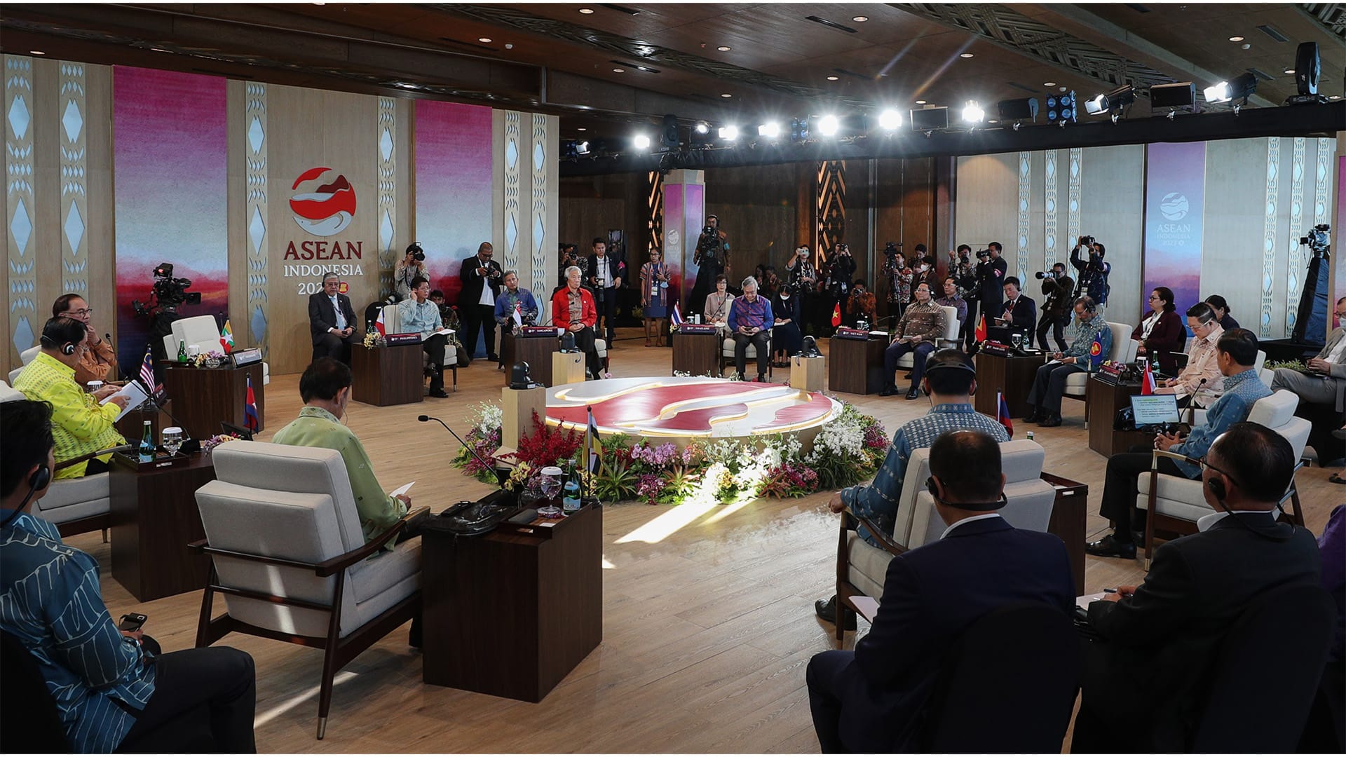 ASEAN Indonesia summit: Delegates seated in a conference hall with photographers at the back.