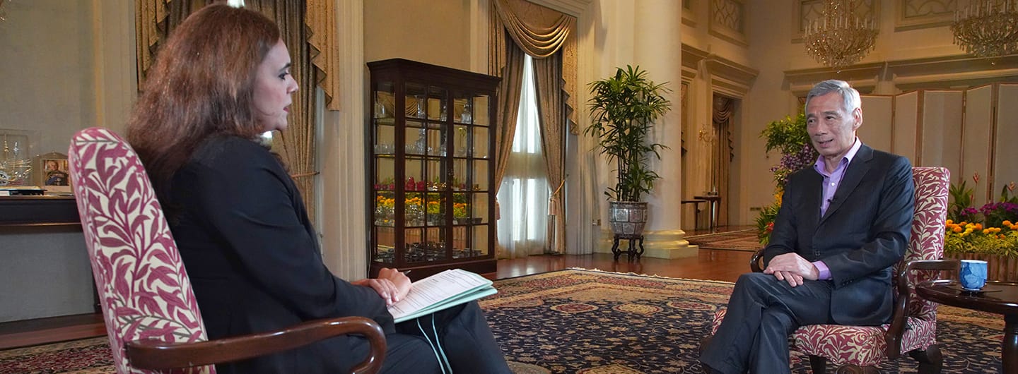 Lee Hsien Loong interviewed indoors, seated across from woman with notes.