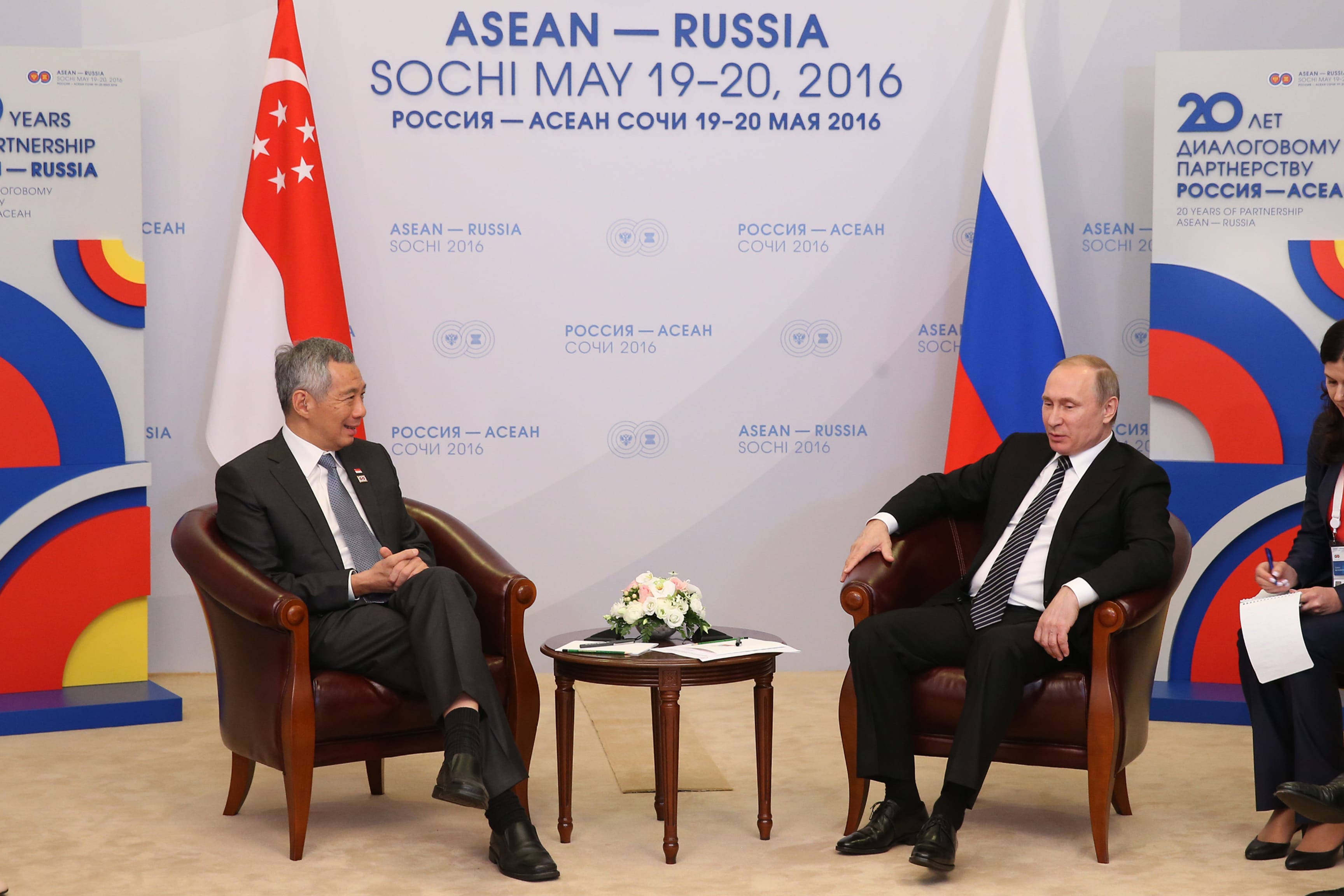 Lee Hsien Loong and Putin seated at ASEAN-Russia summit, with flags behind.
