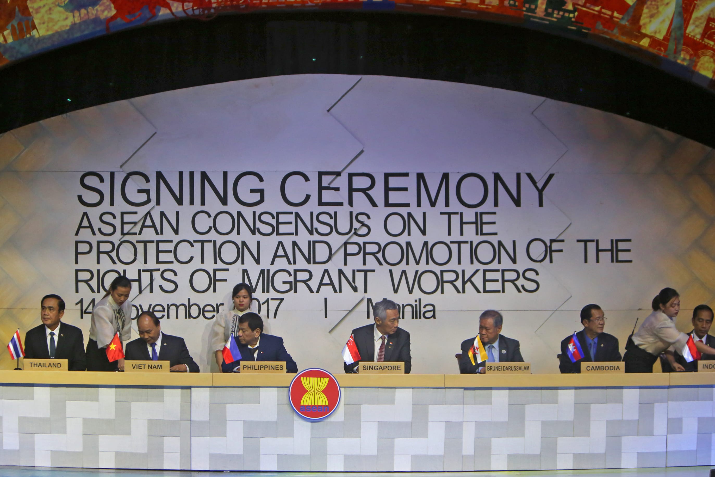 Heads of state at "Signing Ceremony" for ASEAN consensus on migrant worker rights, 14 November 2017, Manila. ASEAN logo.