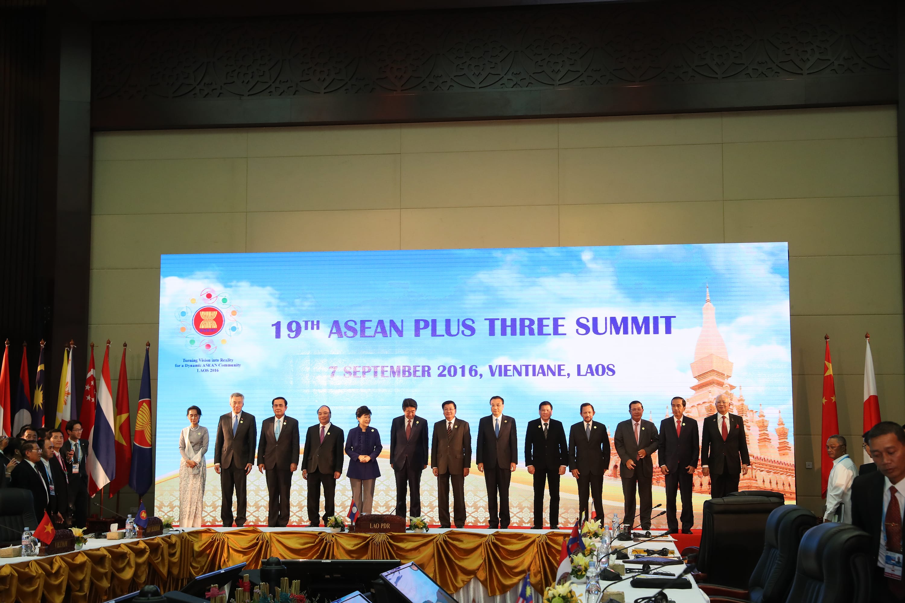 Government officials at 19th ASEAN Plus Three Summit, Vientiane, Laos. Flags shown.
