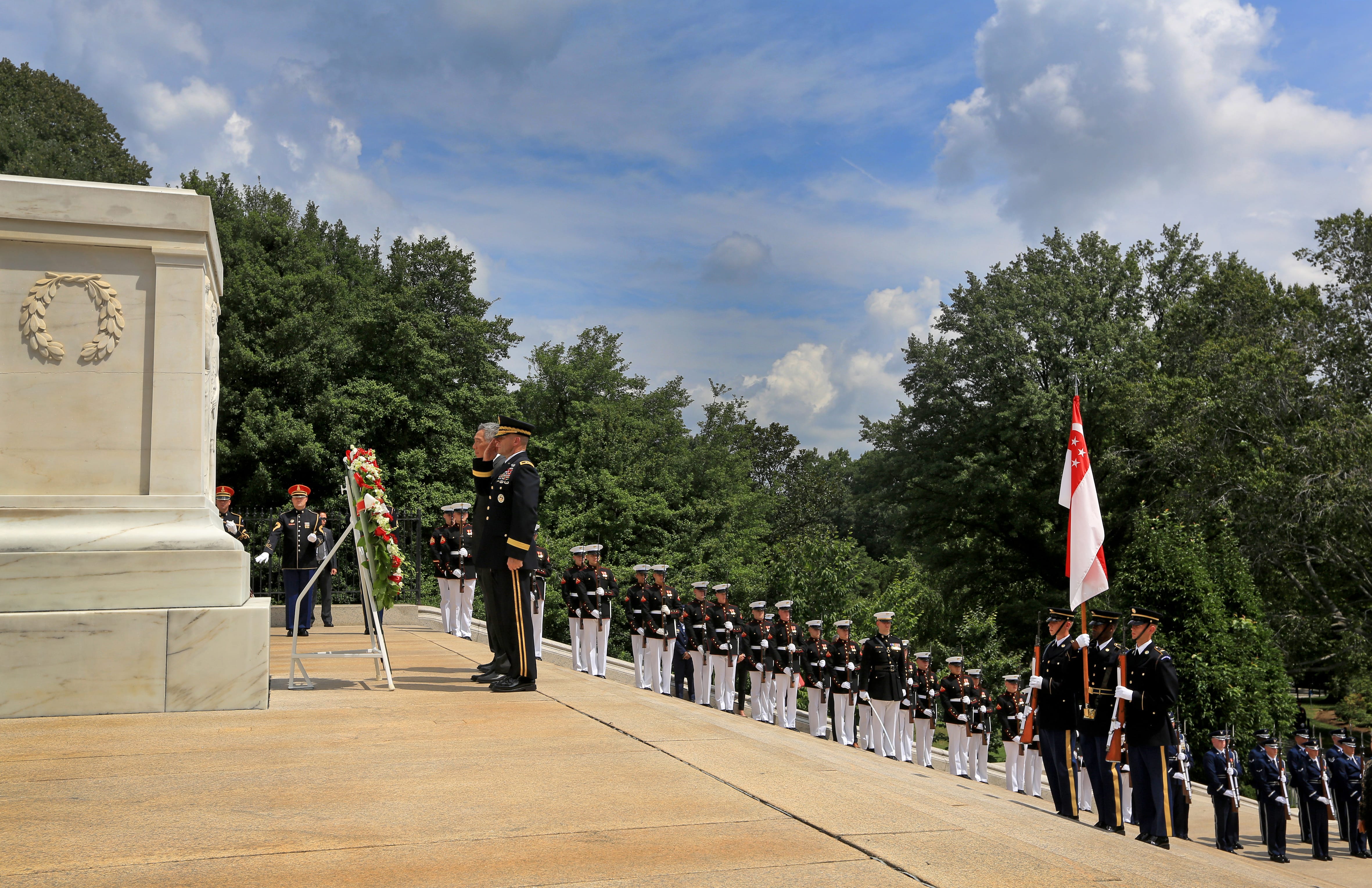 Ceremony at Tomb of the Unknown Soldier; uniformed personnel, wreath, Singapore flag.