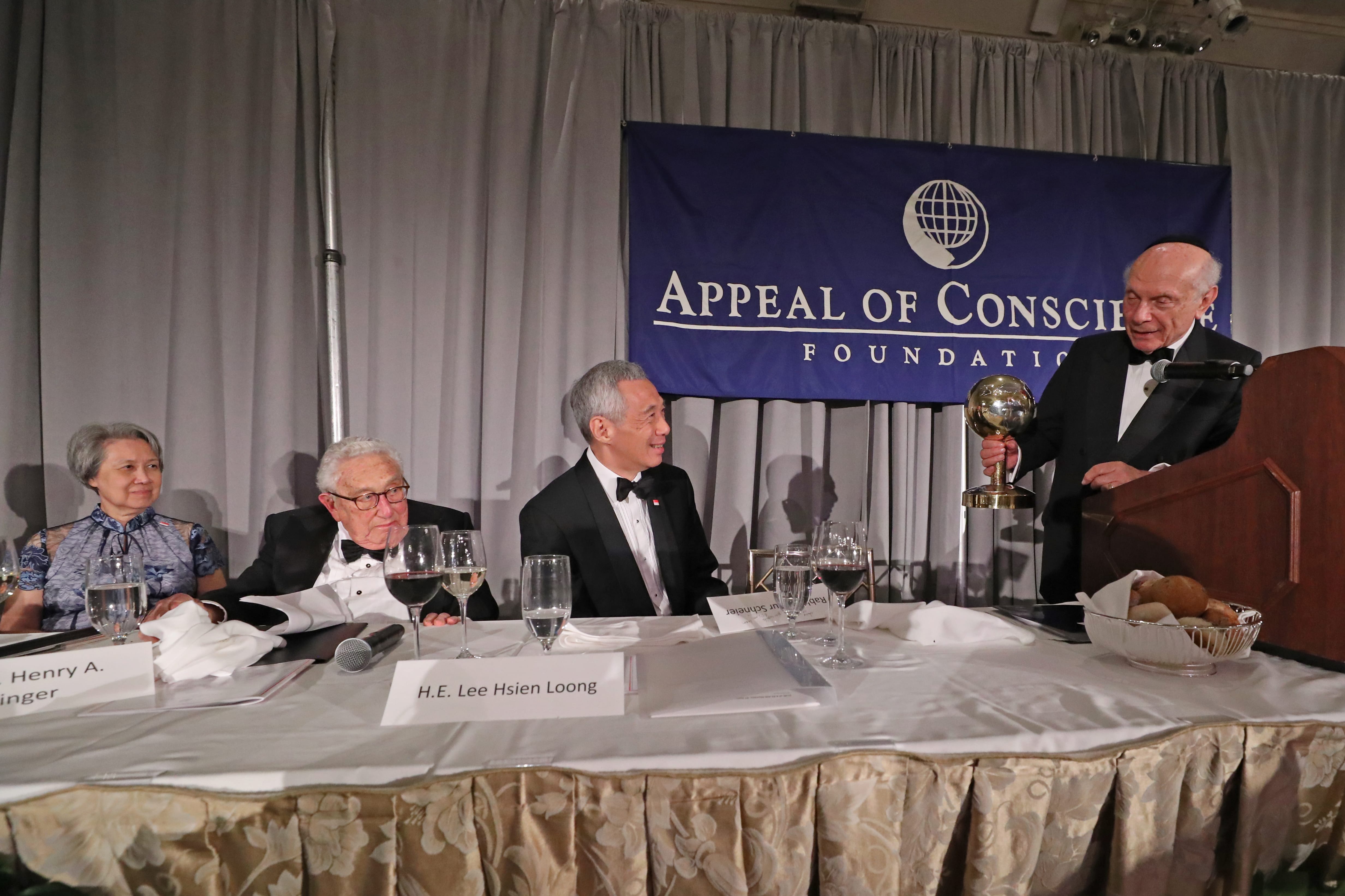 Award ceremony with Henry Kissinger, H.E. Lee Hsien Loong. Appeal of Conscience Foundation banner visible.