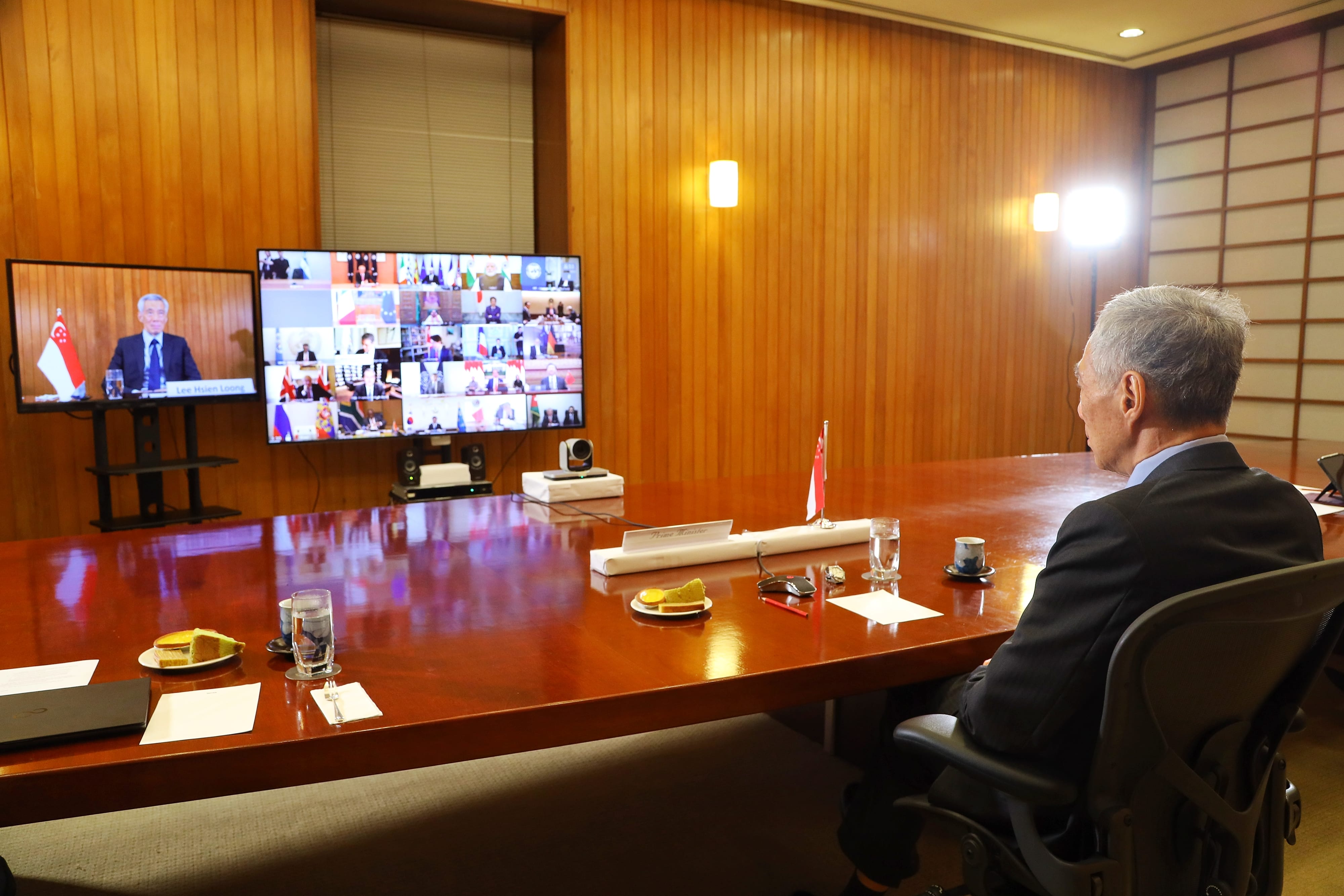Lee Hsien Loong at head of table, video conferencing with multiple world leaders.