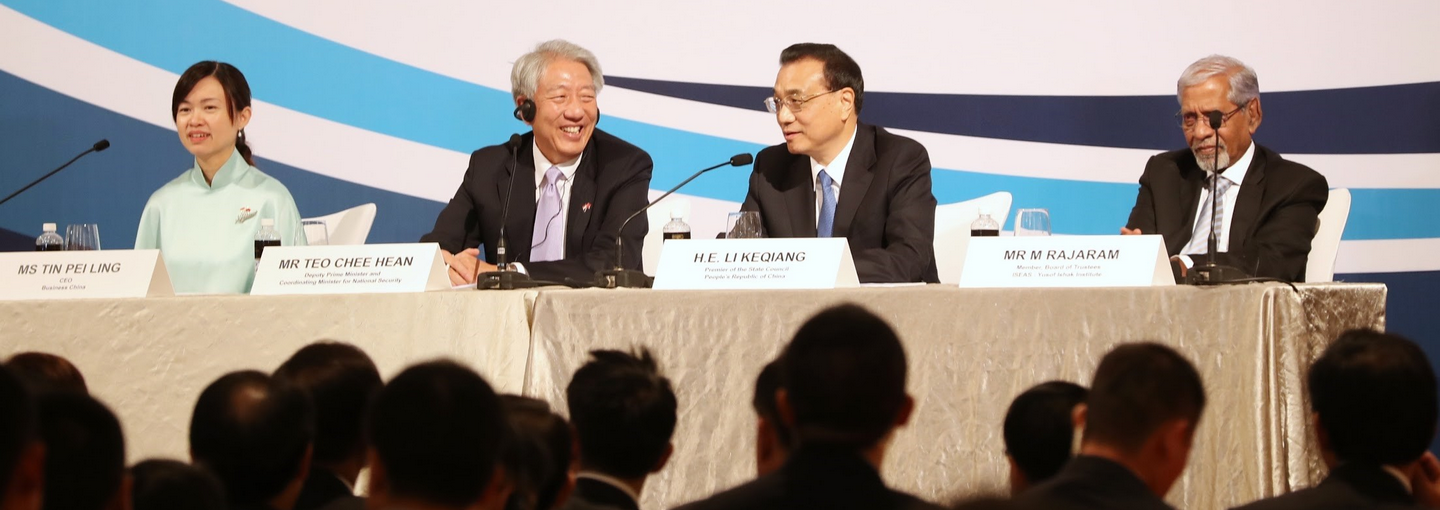 Panel with four people at a table facing an audience.