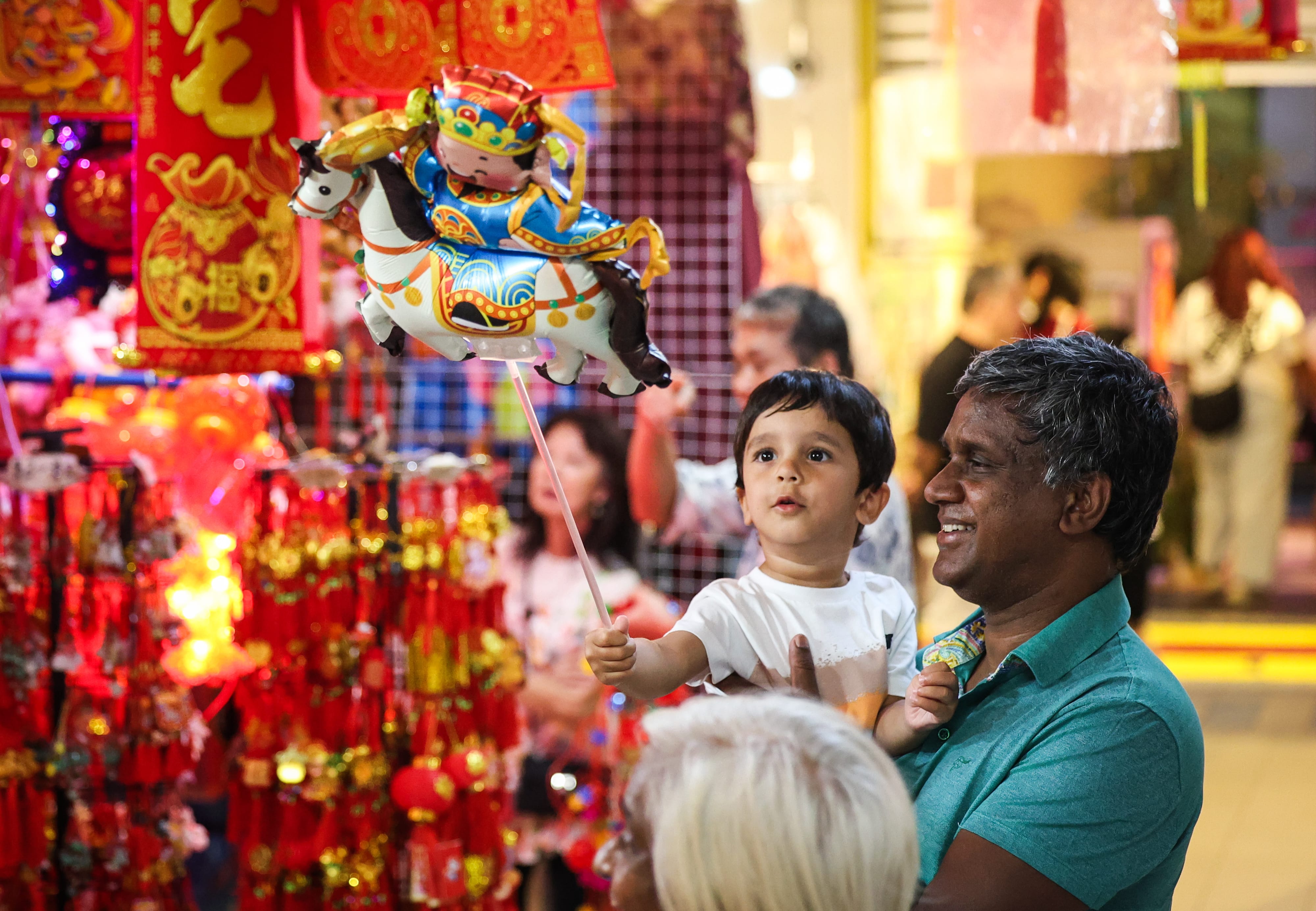 Photo of a father and son playing with Chinese New Year decorations
