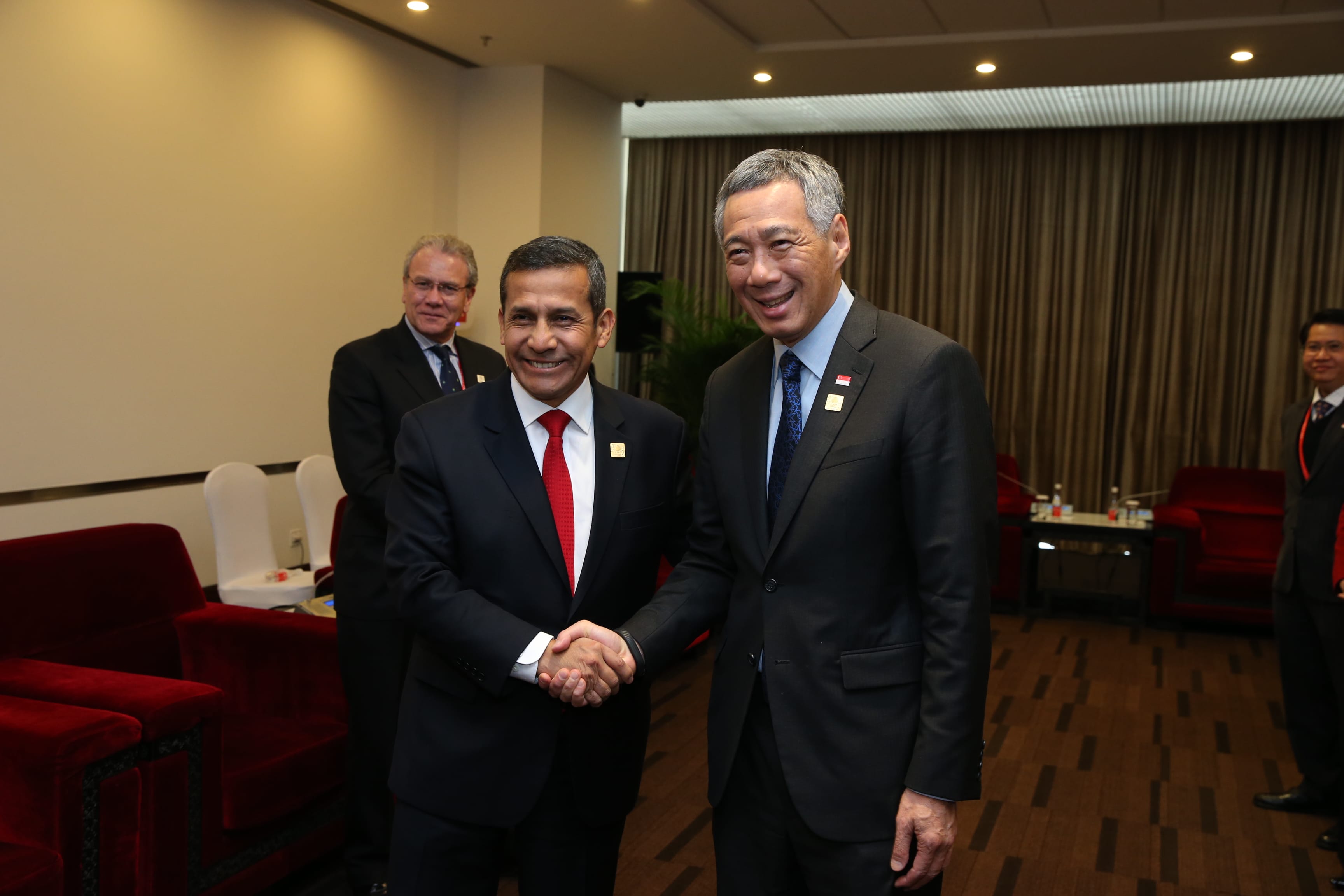 Two men in suits shake hands; Singapore's Prime Minister Lee Hsien Loong is on the right.