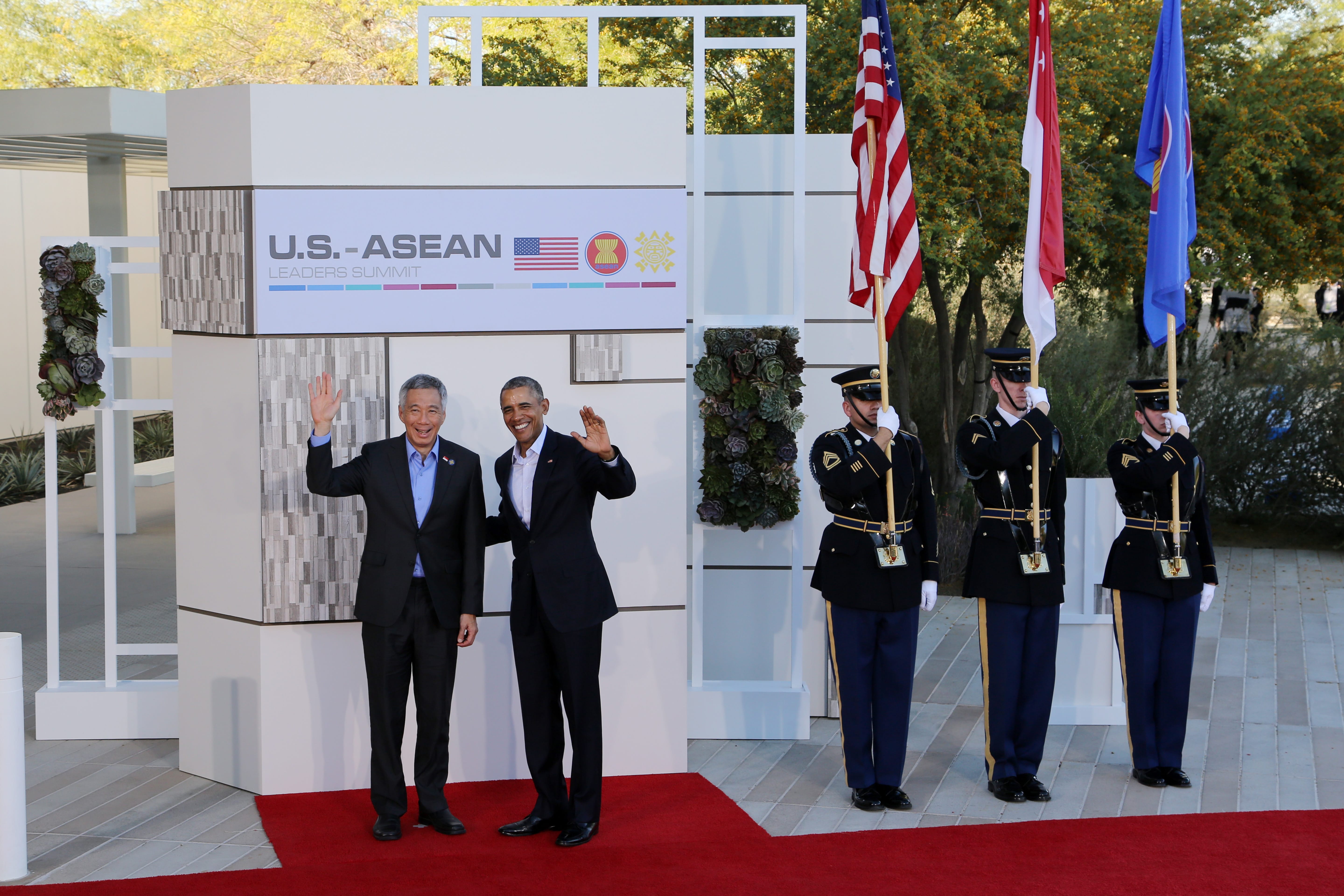 U.S.-ASEAN leaders summit with Obama and Lee Hsien Loong waving, color guard holds flags.