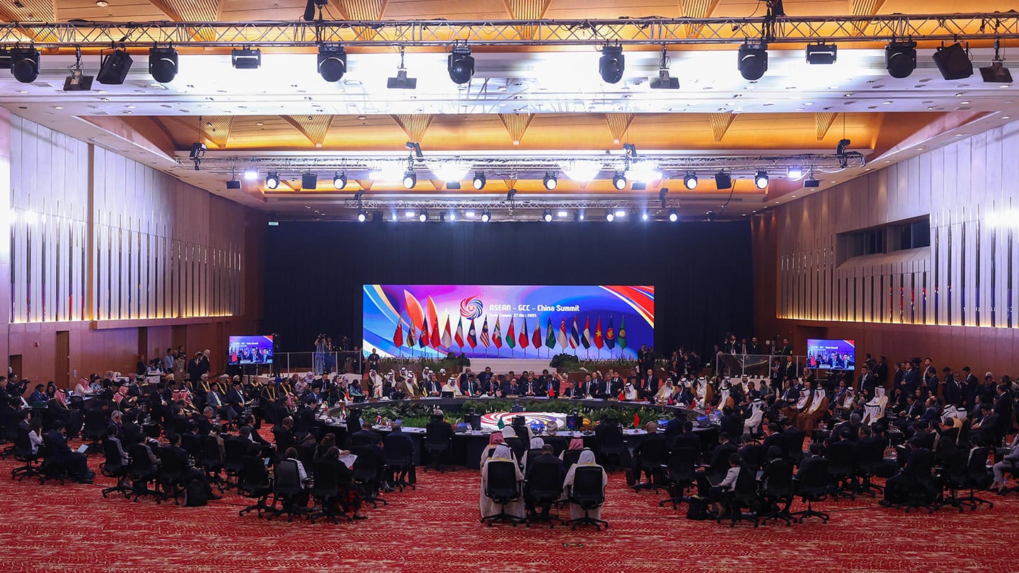 ASEAN-GCC-China Summit with many attendees seated in an auditorium, under lights and flags.