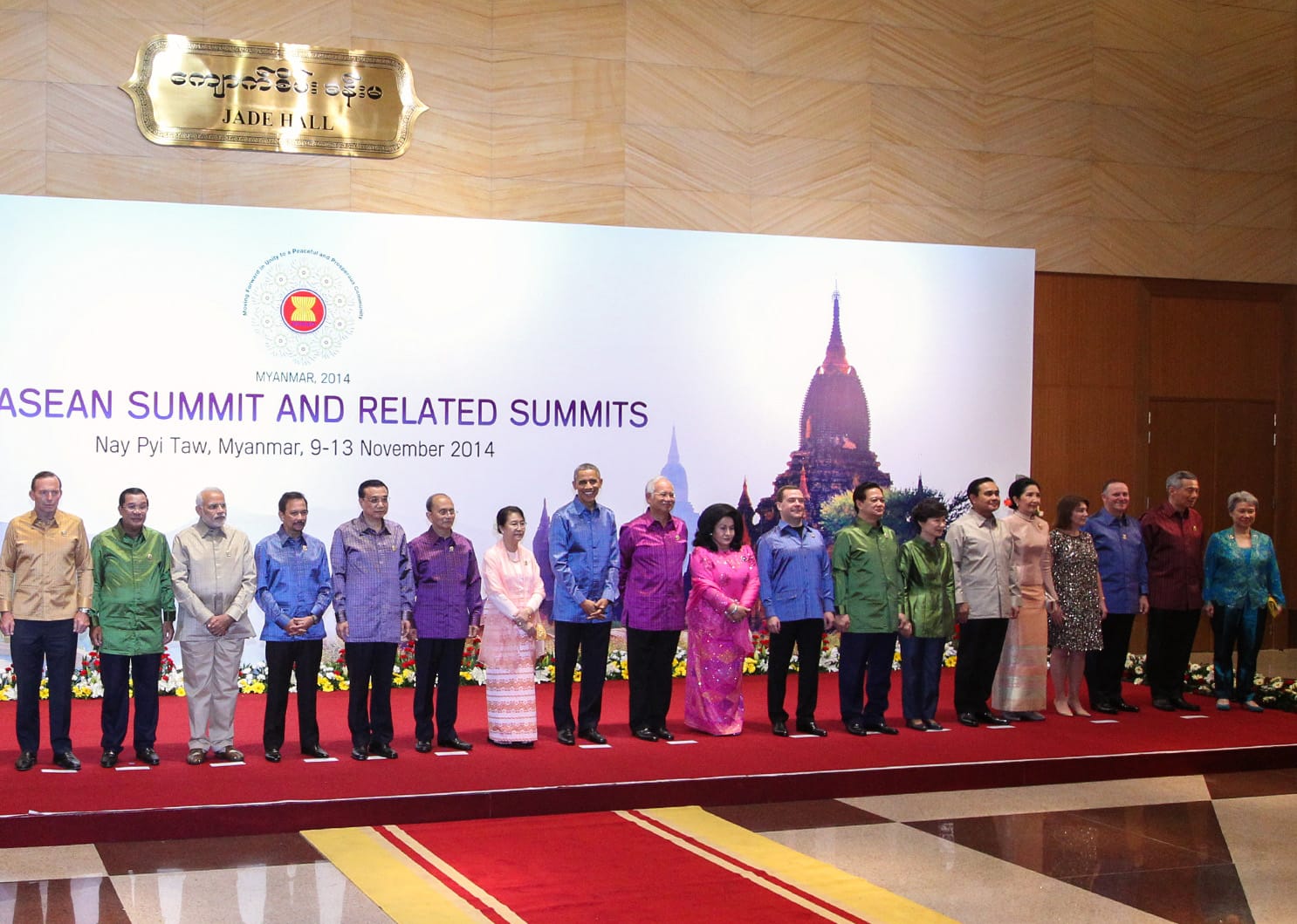 Heads of state at the 2014 ASEAN Summit standing before a backdrop of Myanmar temples.