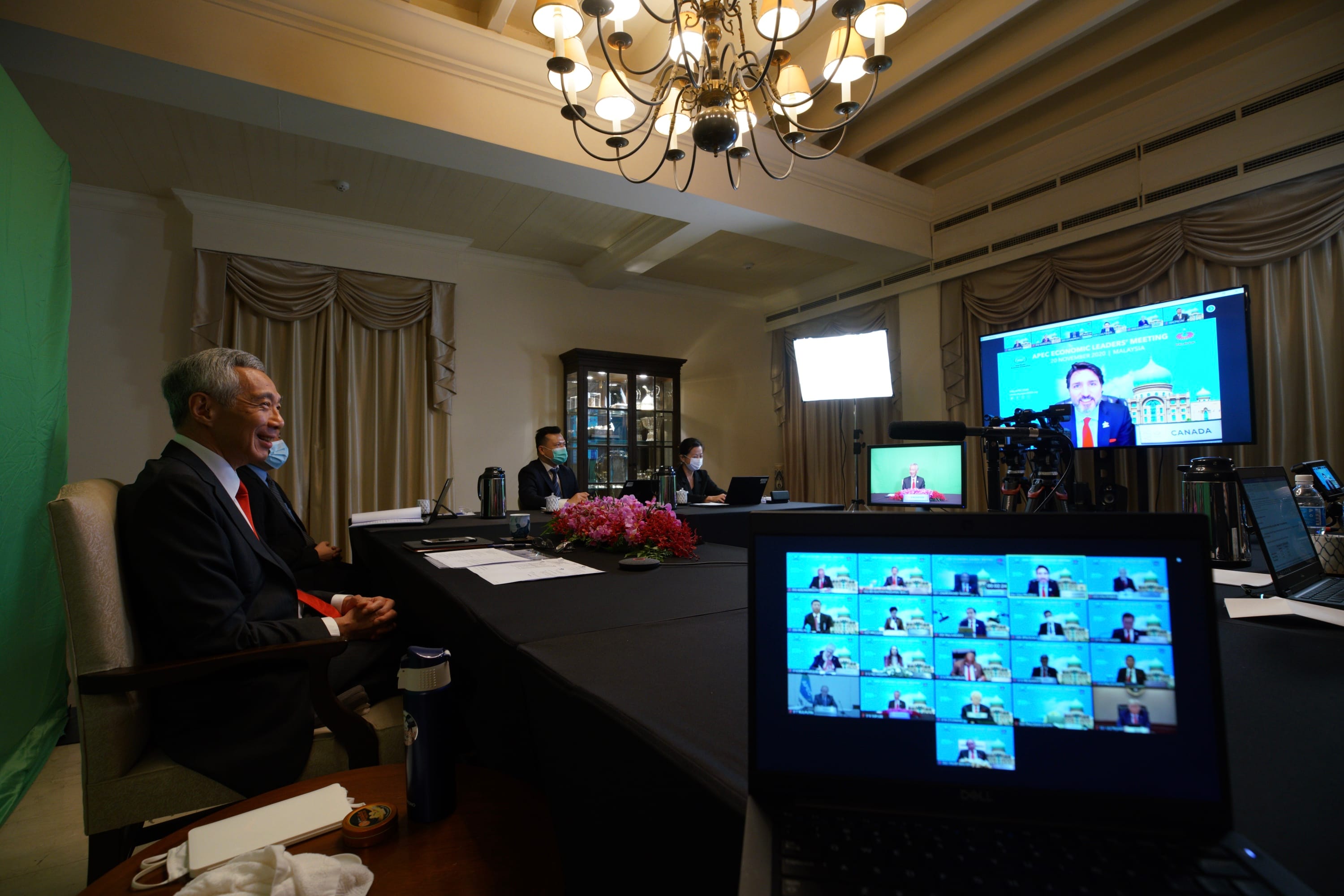 Lee Hsien Loong at a meeting with a video call on screen.