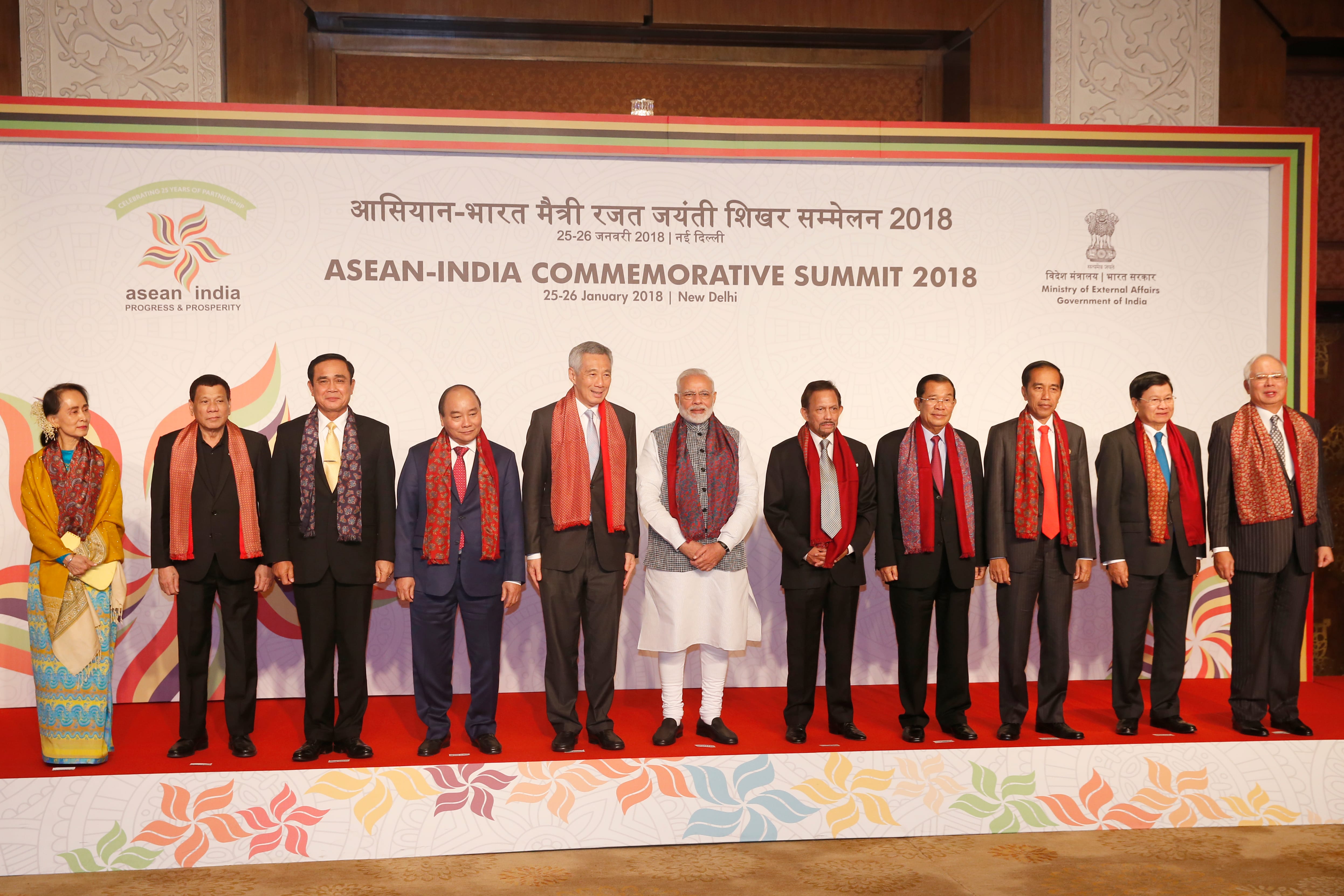 Group of dignitaries at ASEAN-India summit 2018, wearing scarves.