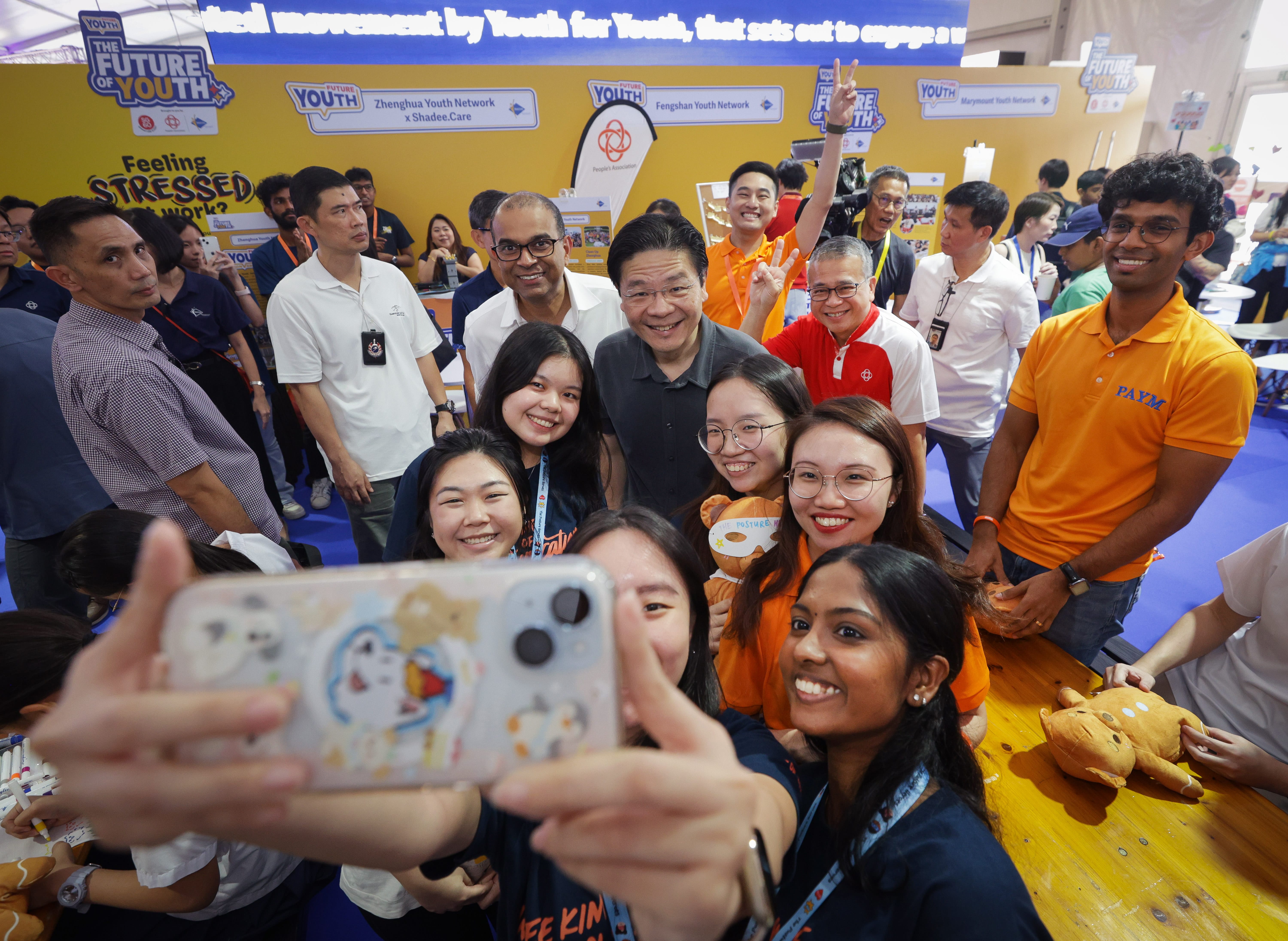 Photo of youths taking a selfie with PM Wong at the launch of the People's Association Youth Charter in 2025