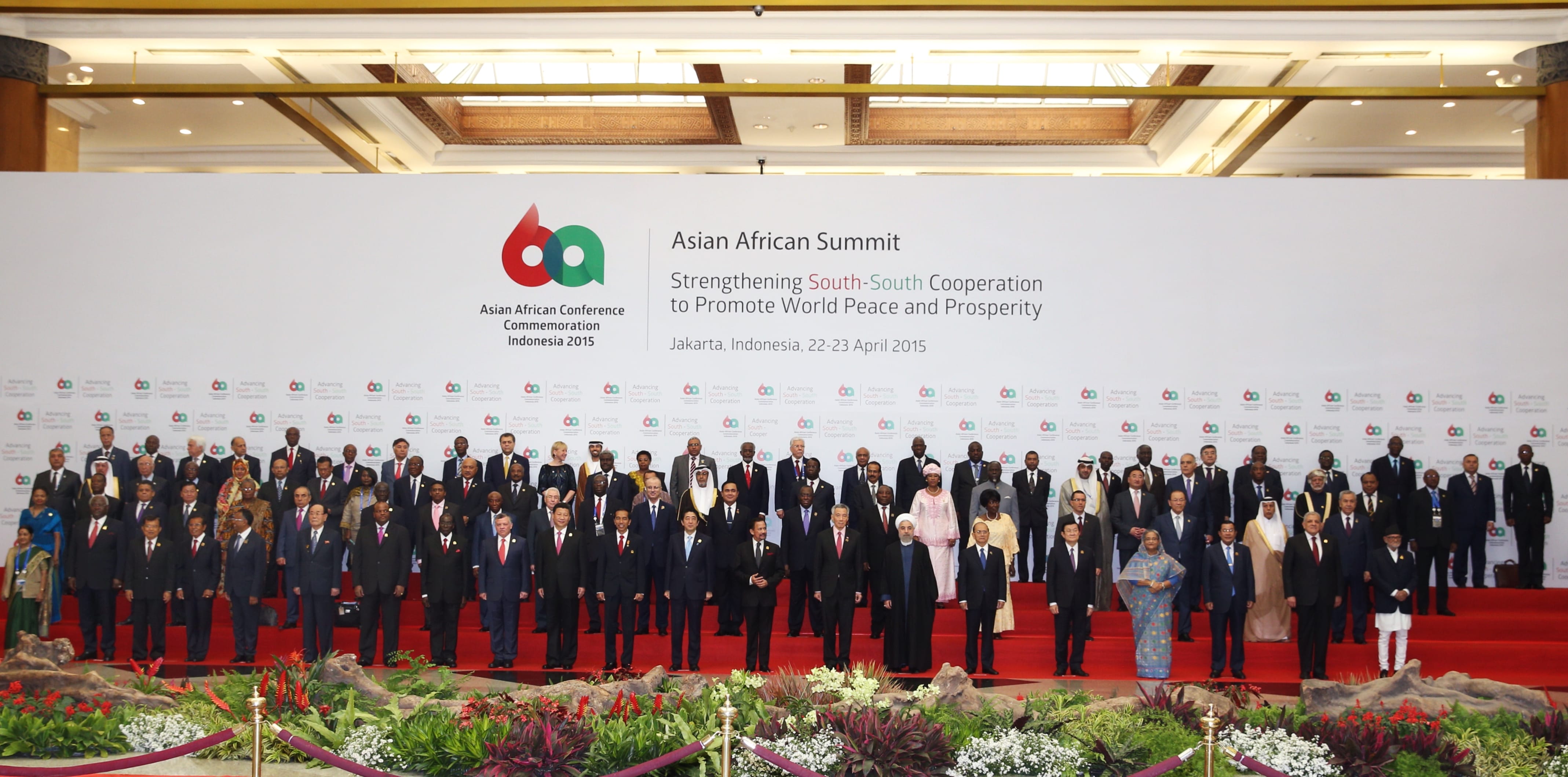Group photo of diverse leaders at Asian African Summit 2015, Jakarta. Backdrop banner has event details.