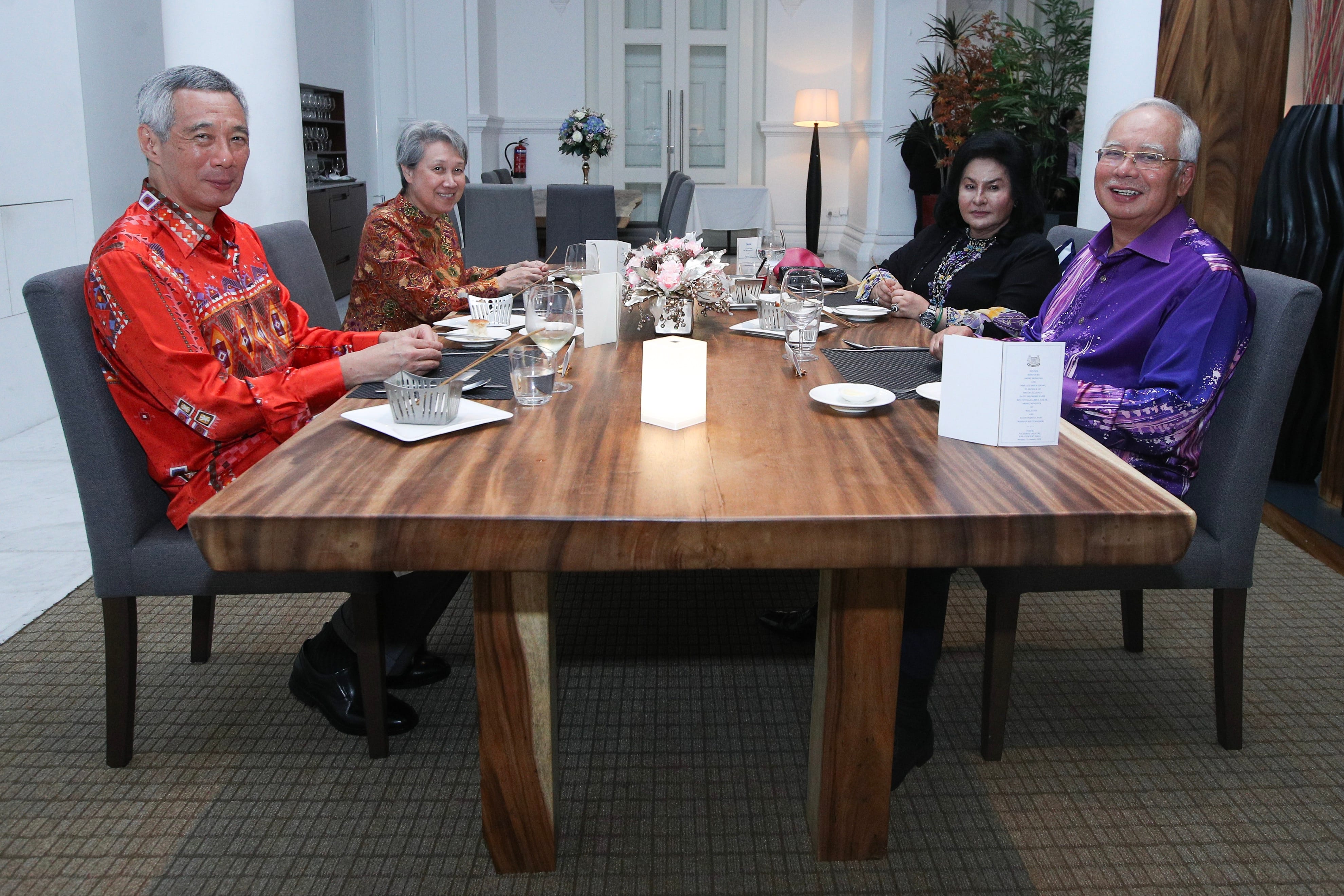 Four people at a table during a meal; Lee Hsien Loong, Najib Razak visible.