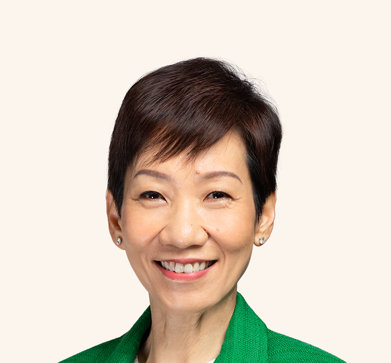 Minister Grace Fu in green blazer, smiling warmly against a light background.