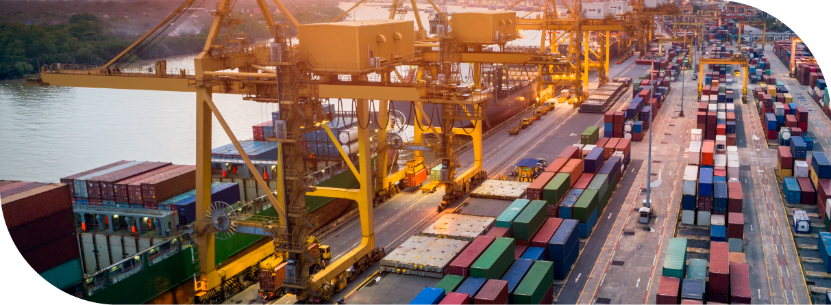 Aerial view of cargo containers and cranes at a busy port terminal.