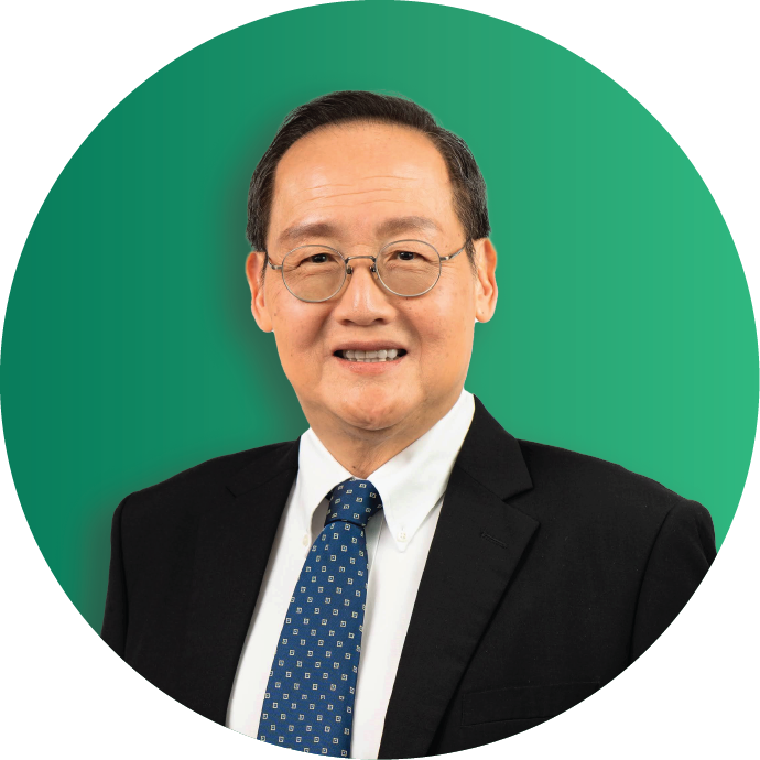 Second Minister for Trade and Industry, Dr Tan See Leng in in black suit with blue tie smiling against a green circular