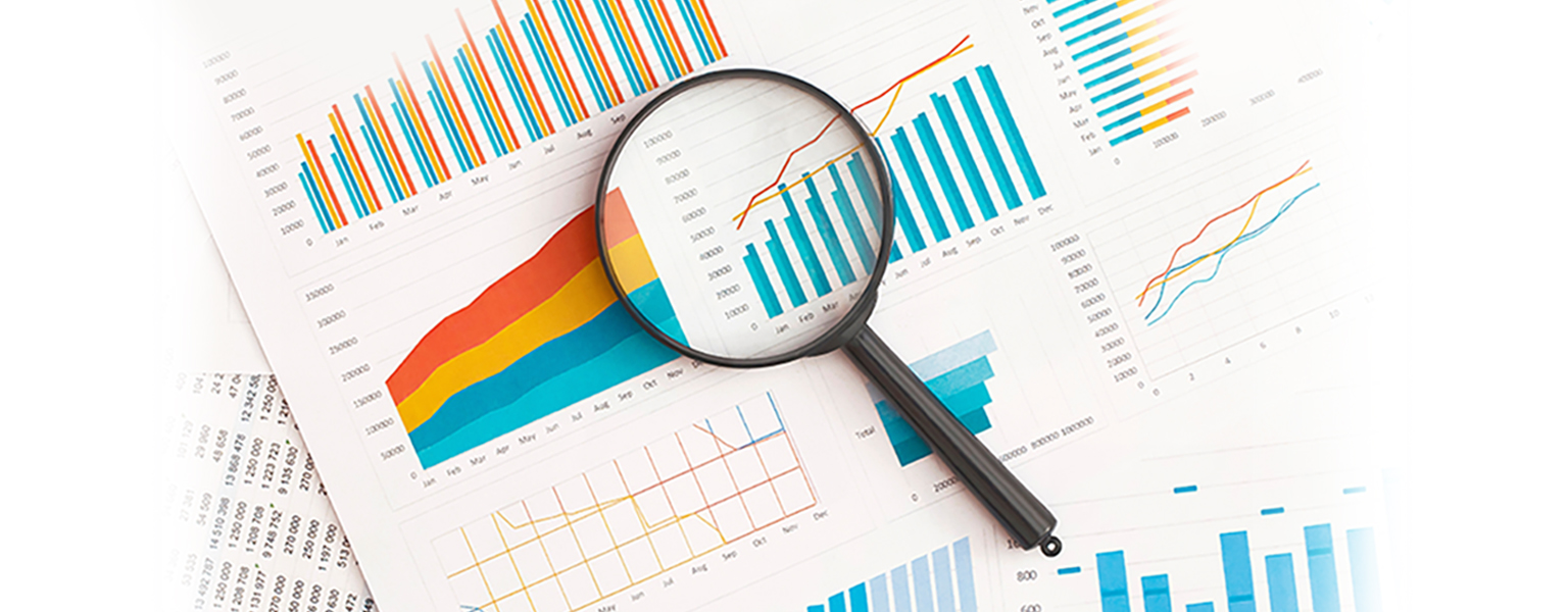 Data-driven business analysis with magnifying glass, showcasing insights from charts and graphs.