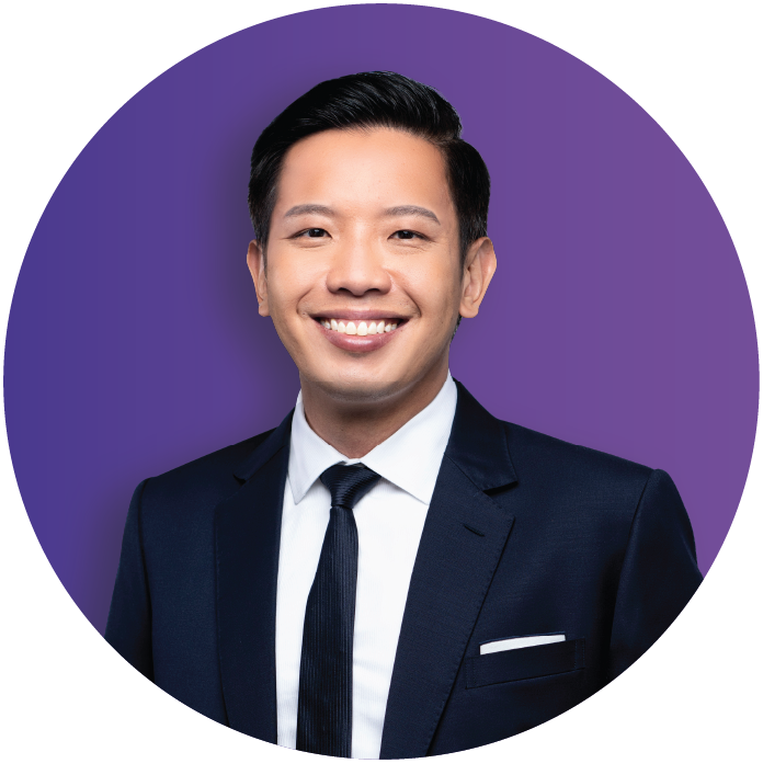 Minister of State for Trade and Industry, Mr Alvin Tan in dark suit and tie smiling against a purple background.