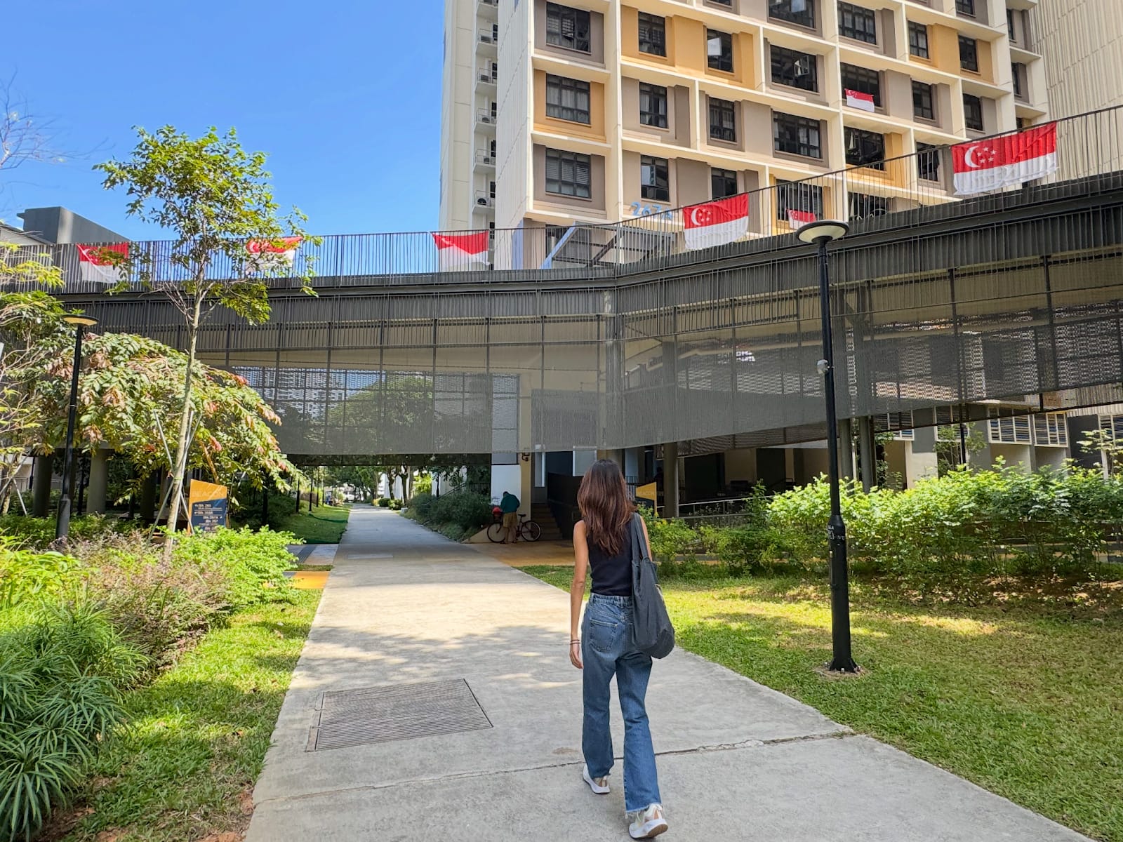 A woman walking along a path in a BTO project.