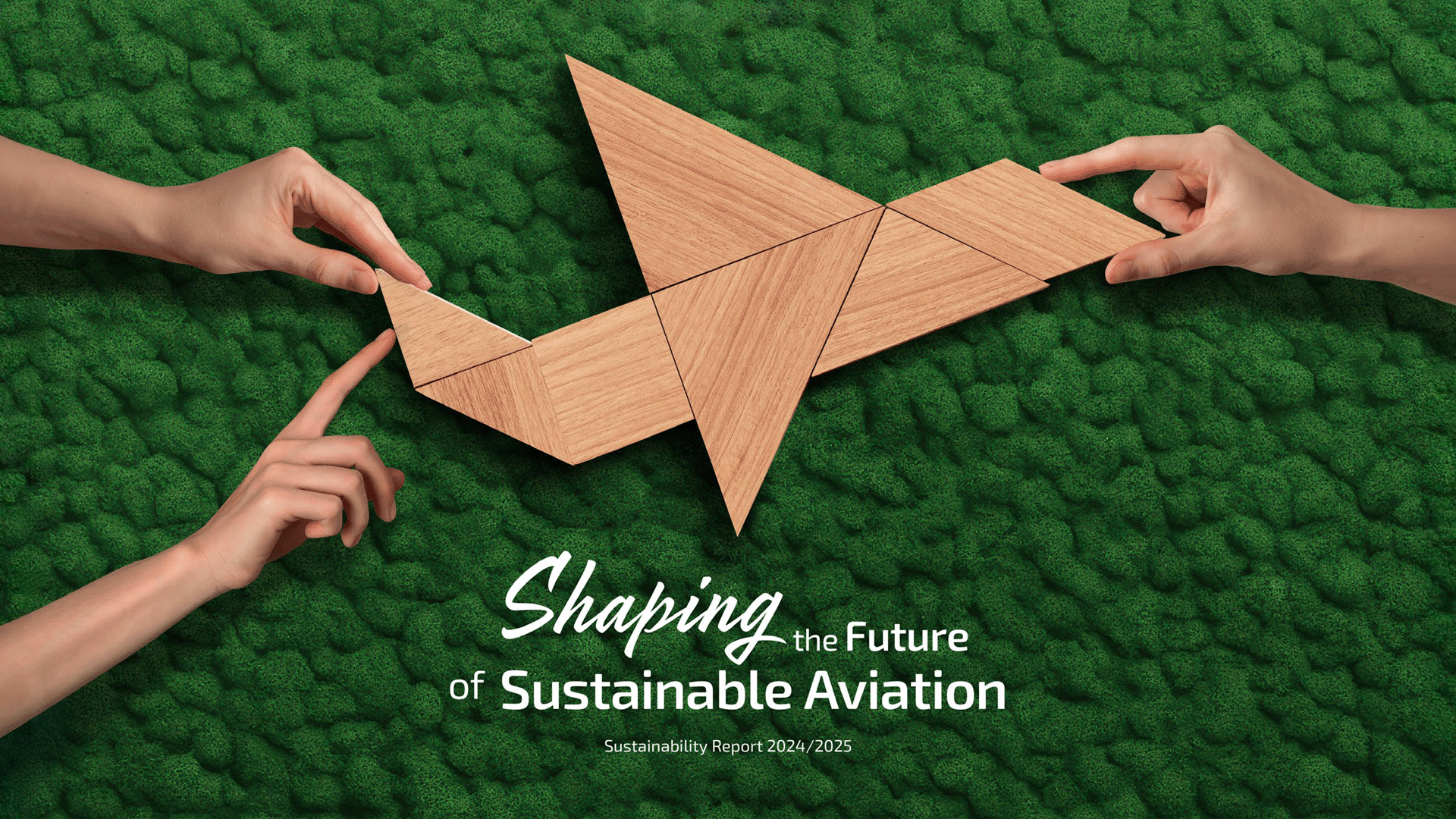 Hands assembling a wooden origami-style bird over a green moss background, with the title ‘Shaping the Future of Sustainable Aviation’
