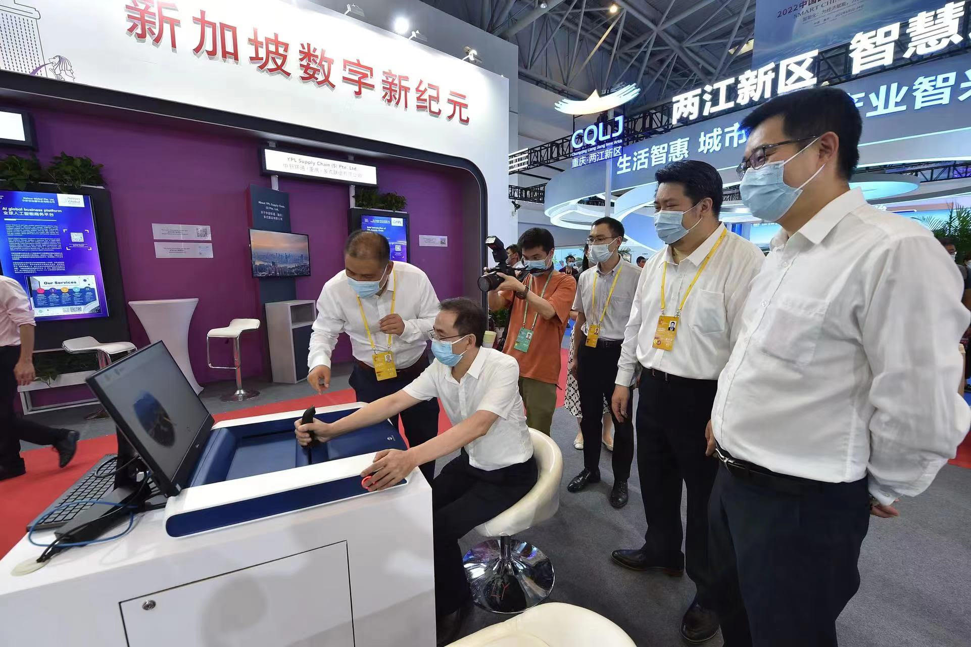 Trade show booth: masked man using a device with onlookers and a photographer.