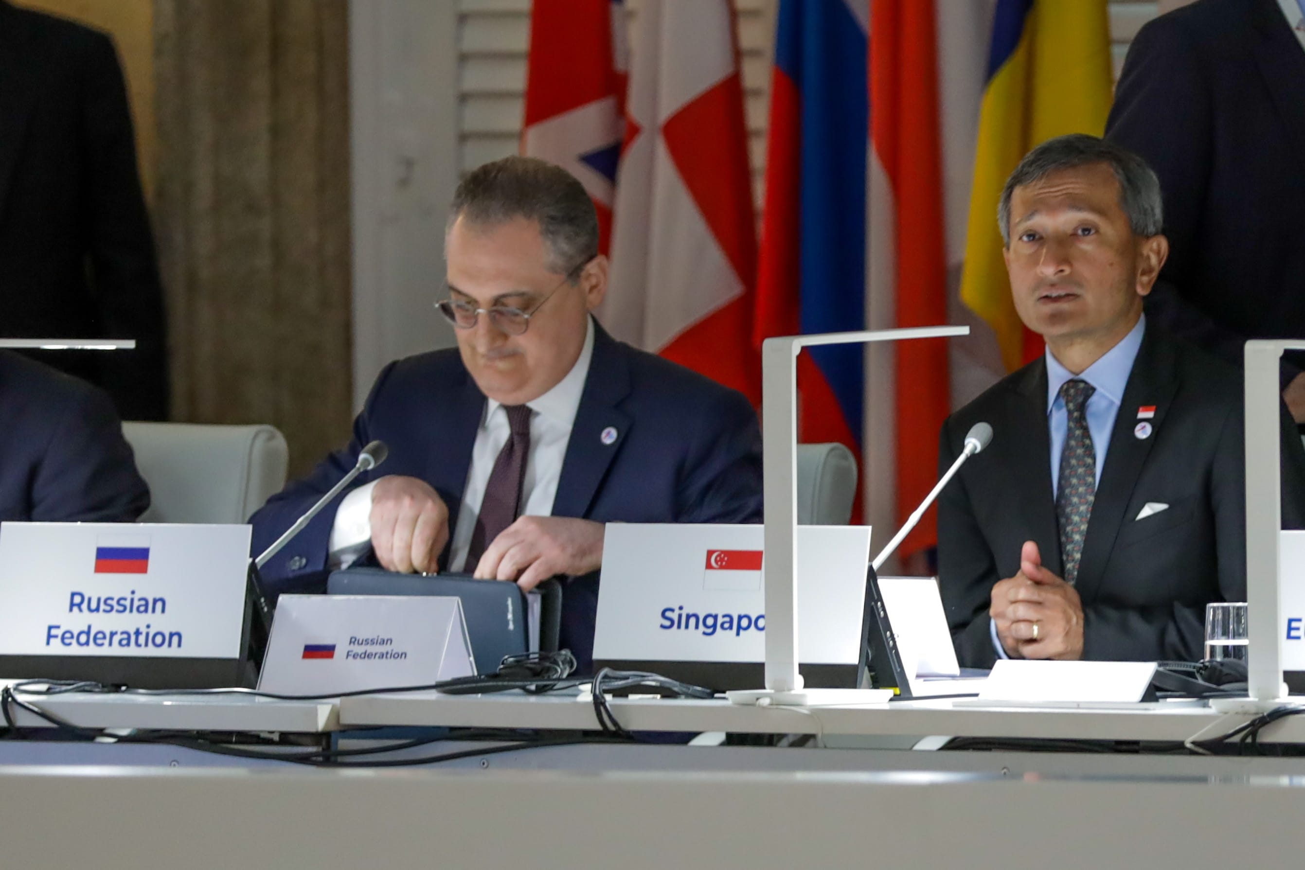 Man at "Arctic Frontiers" podium with large snowflake decorations behind him.