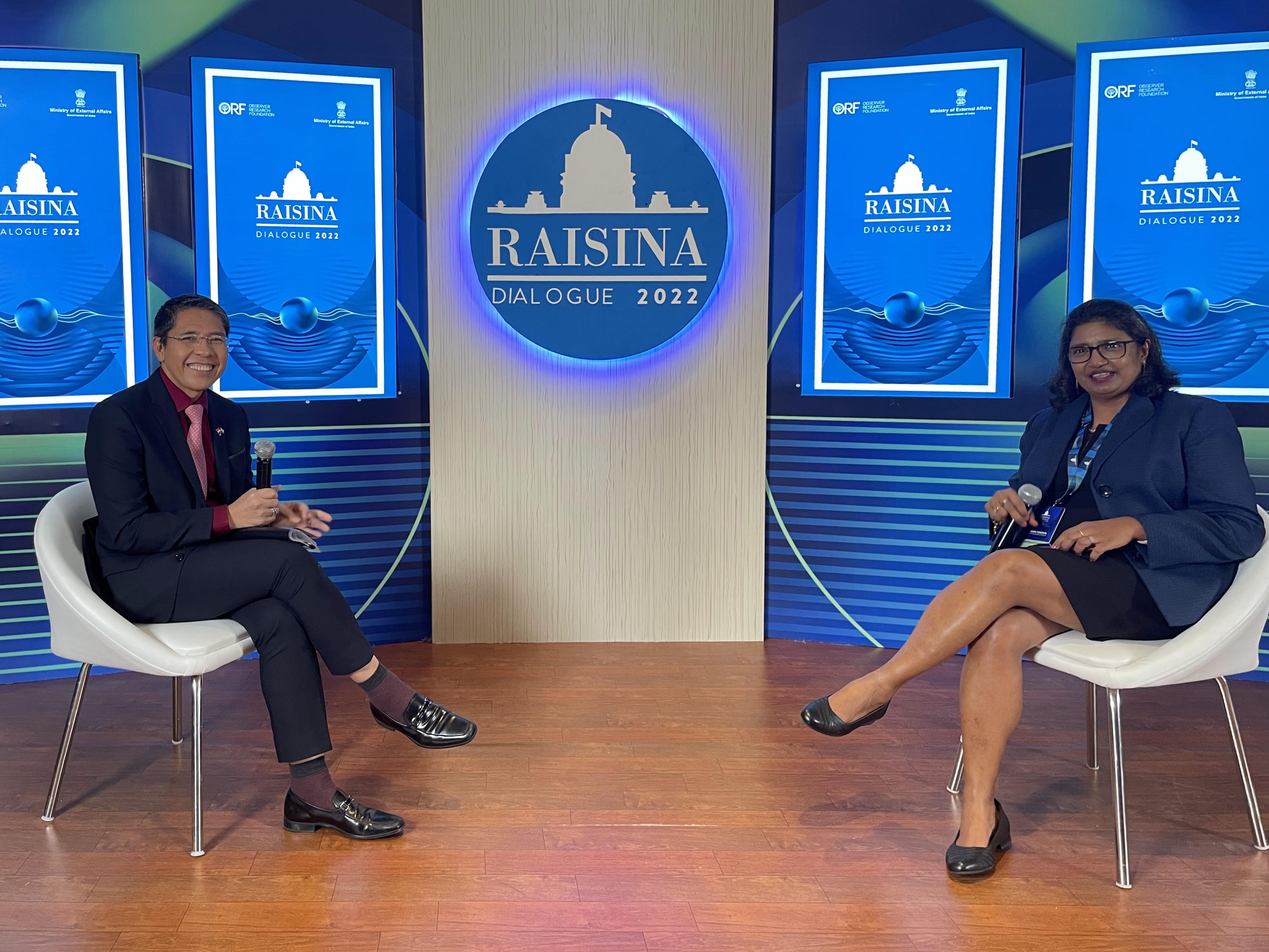 Two panelists on stage; Raisina Dialogue 2022 backdrop with ORF logo.