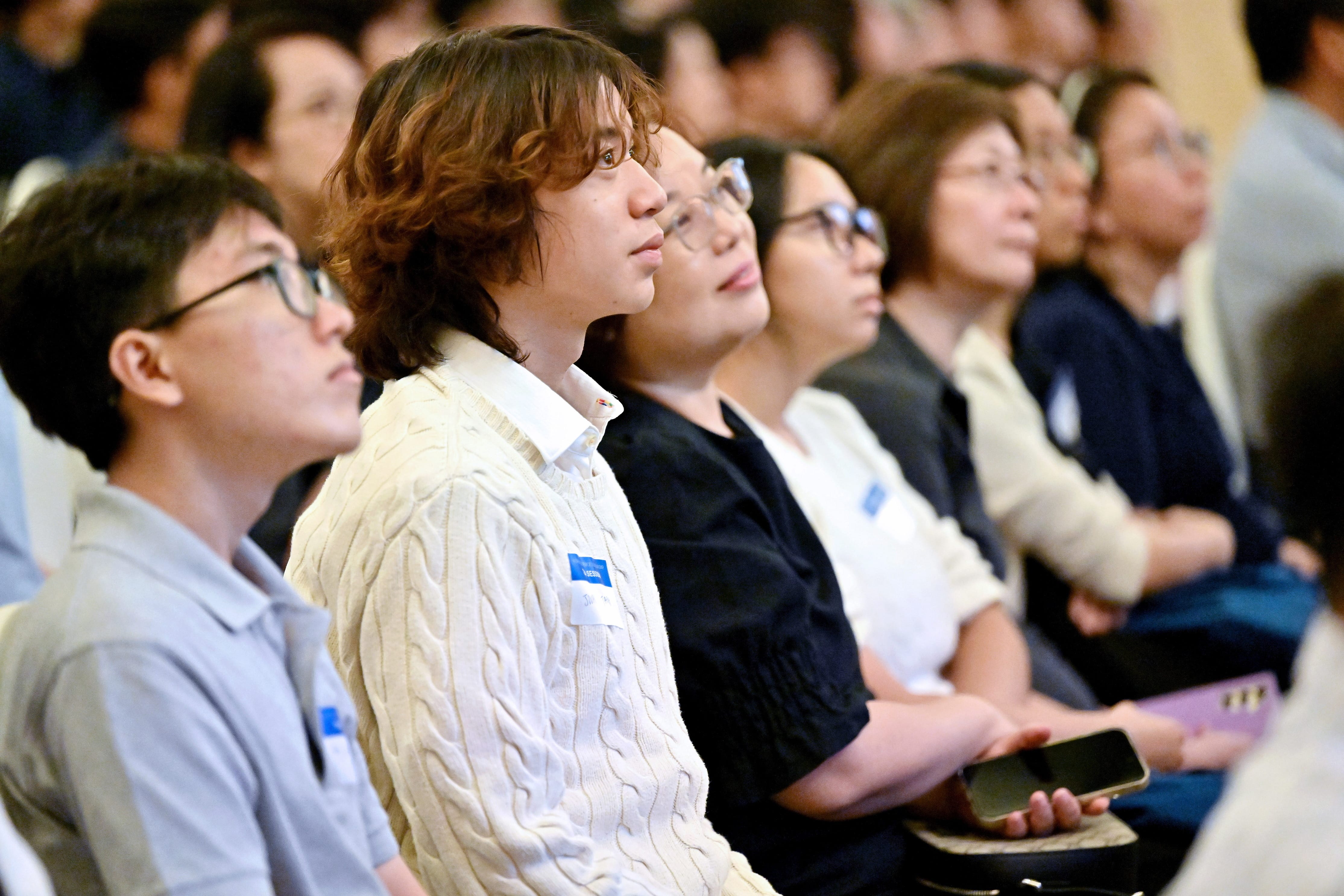 Close-up of students attentively listening during the scholarship session