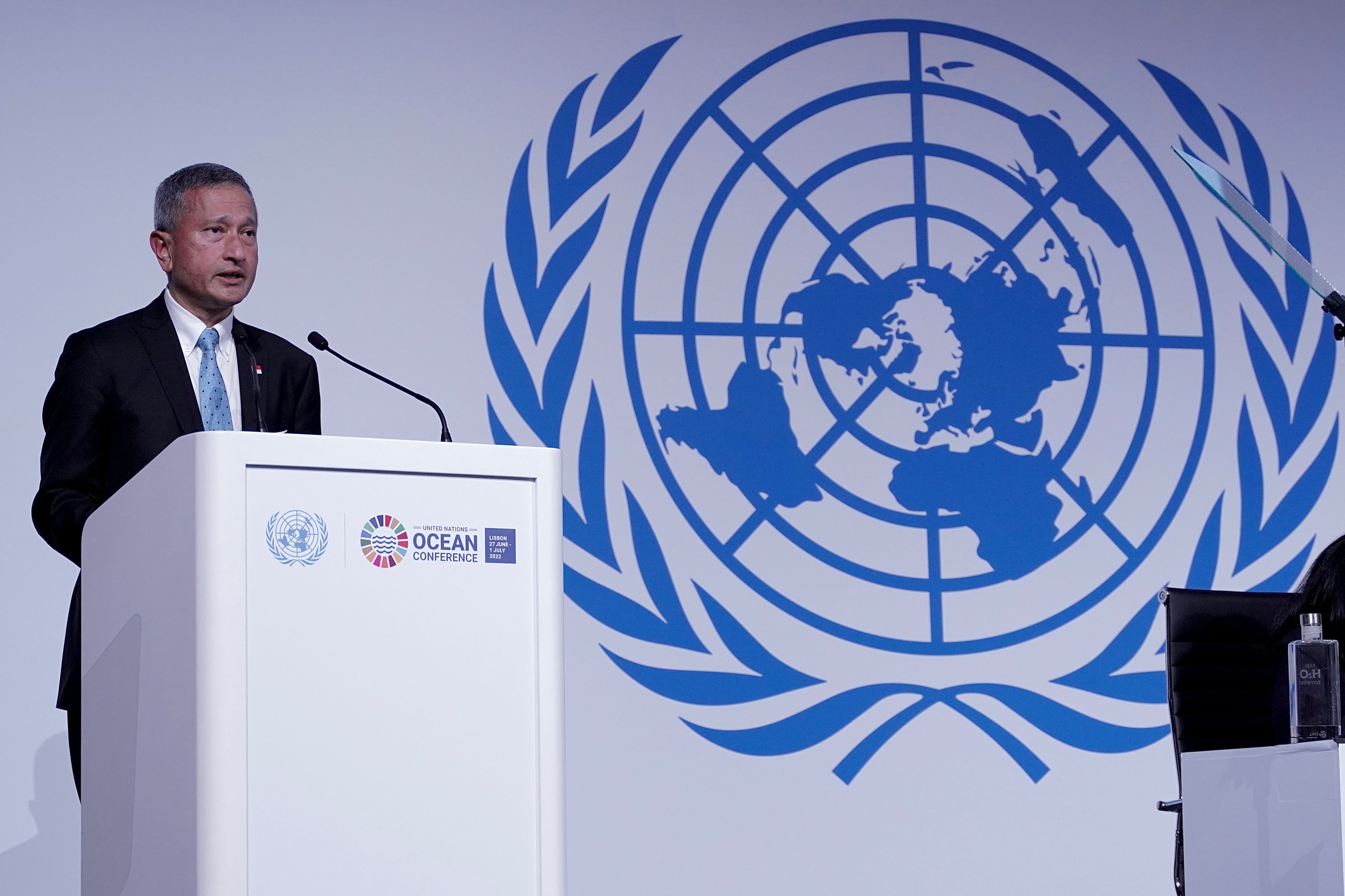 Man speaks at podium with UN Ocean Conference logo before UN emblem backdrop.
