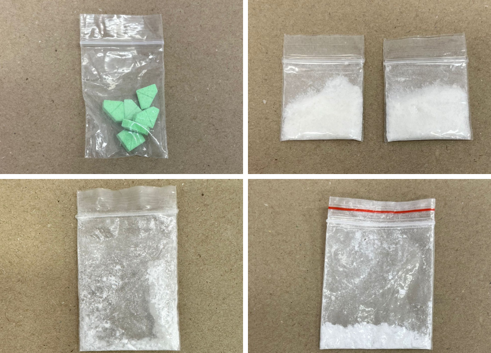 Four small plastic bags. One contains green triangular pills, the others contain white powder.