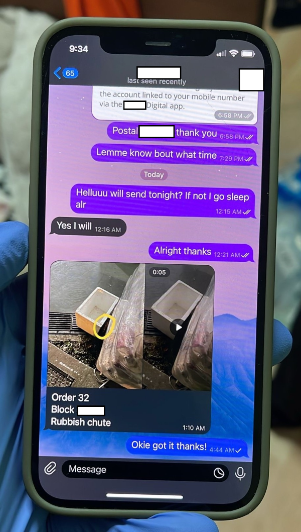 Smartphone showing text message exchange and a video thumbnail of containers by a grate.