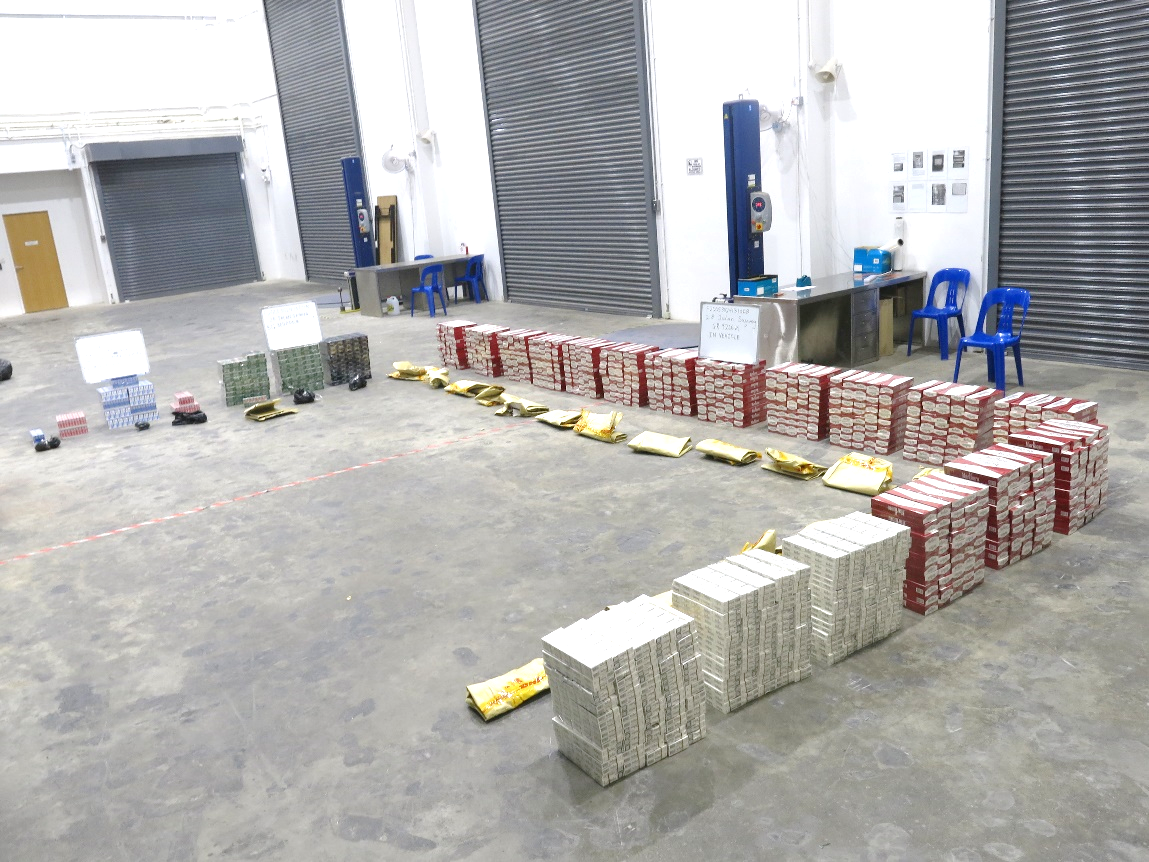 Stacks of packaged goods, gold bags, in a warehouse setting.