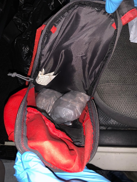 Maroon Mercedes-Benz coupe with black rims parked in an indoor garage.