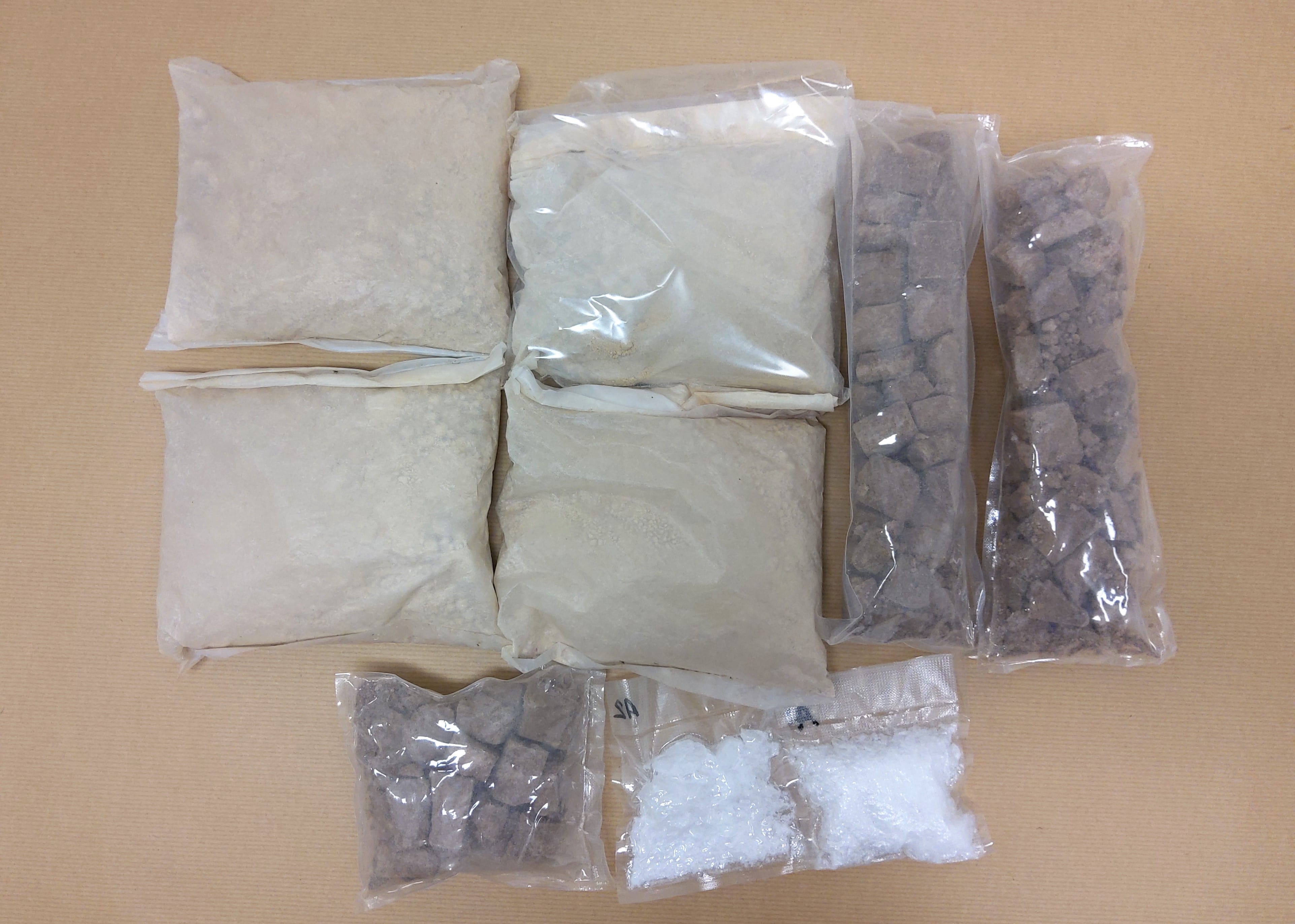 Singapore's National Stadium at night, lit with green lights, reflected in the water.