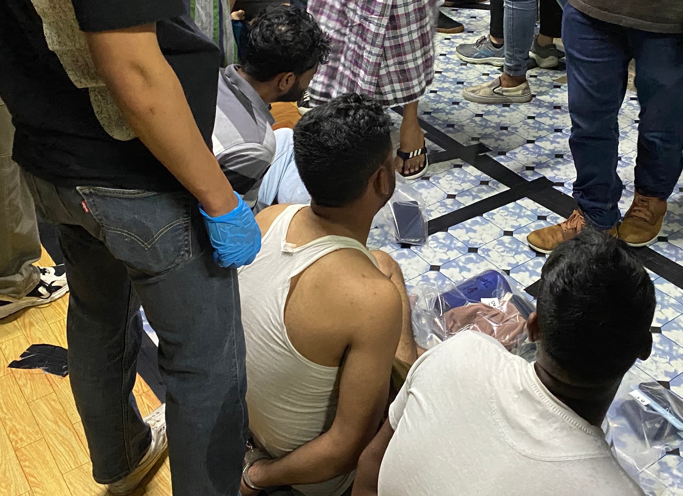 Suspected drug offenders arrested by CNB officers at a residential lodging in the vicinity of Woodlands in the early hours of 28 November 2025.
