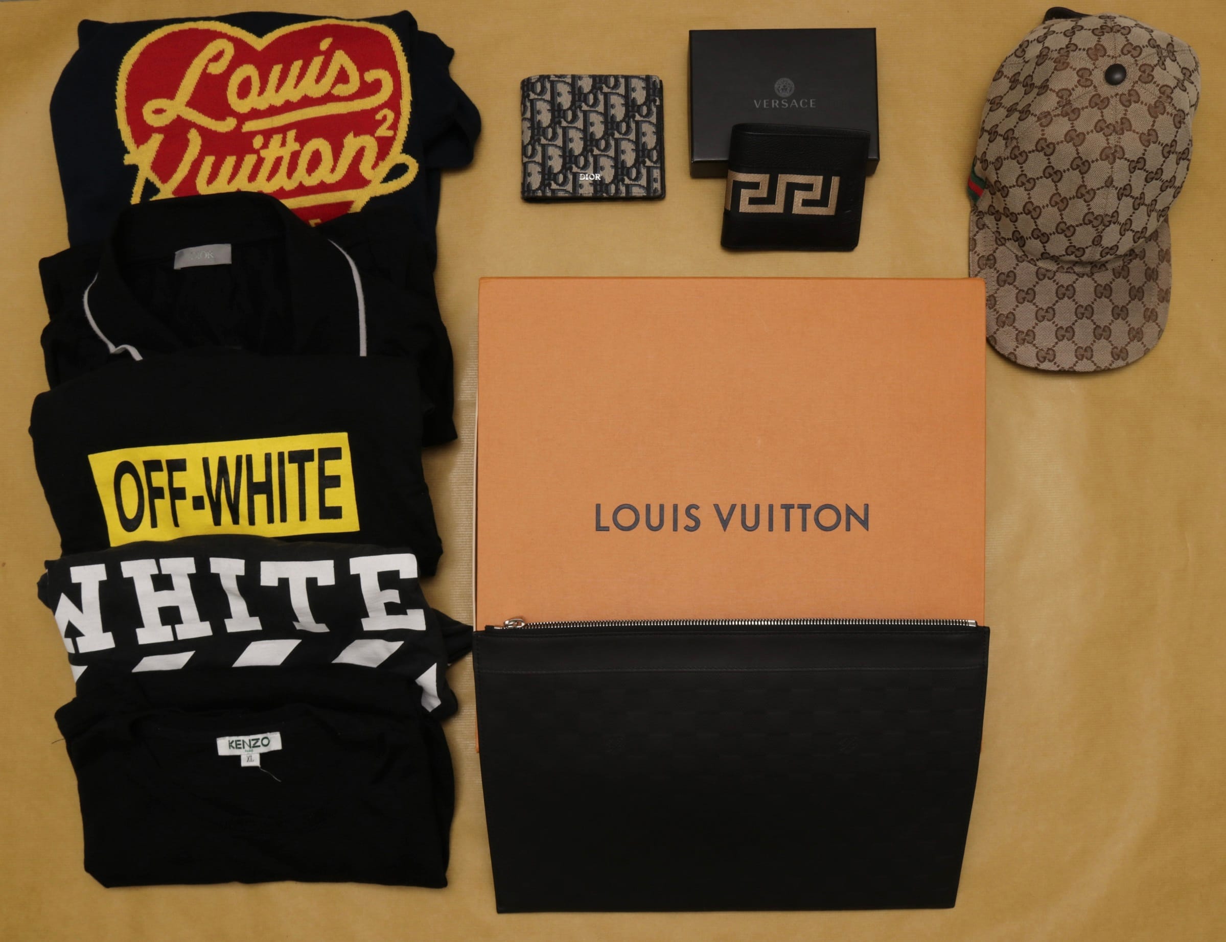 Luxury brands: Louis Vuitton apparel/box, Dior wallet/shirt, Versace wallet/box, Off-White shirt, Kenzo shirt, Gucci hat.