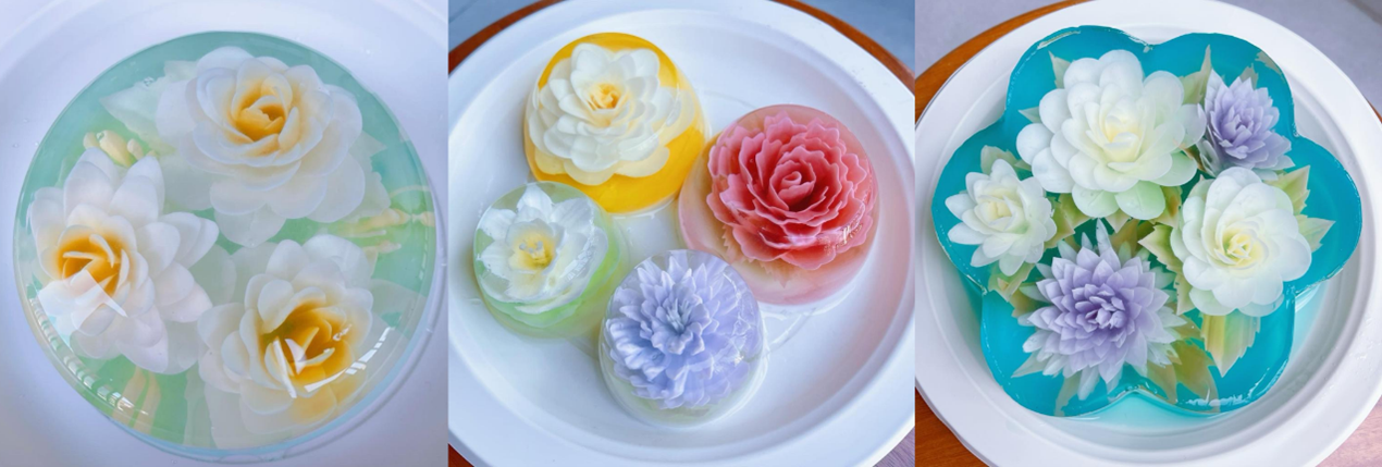 Three colorful gelatin desserts in various flower shapes are shown on white plates.