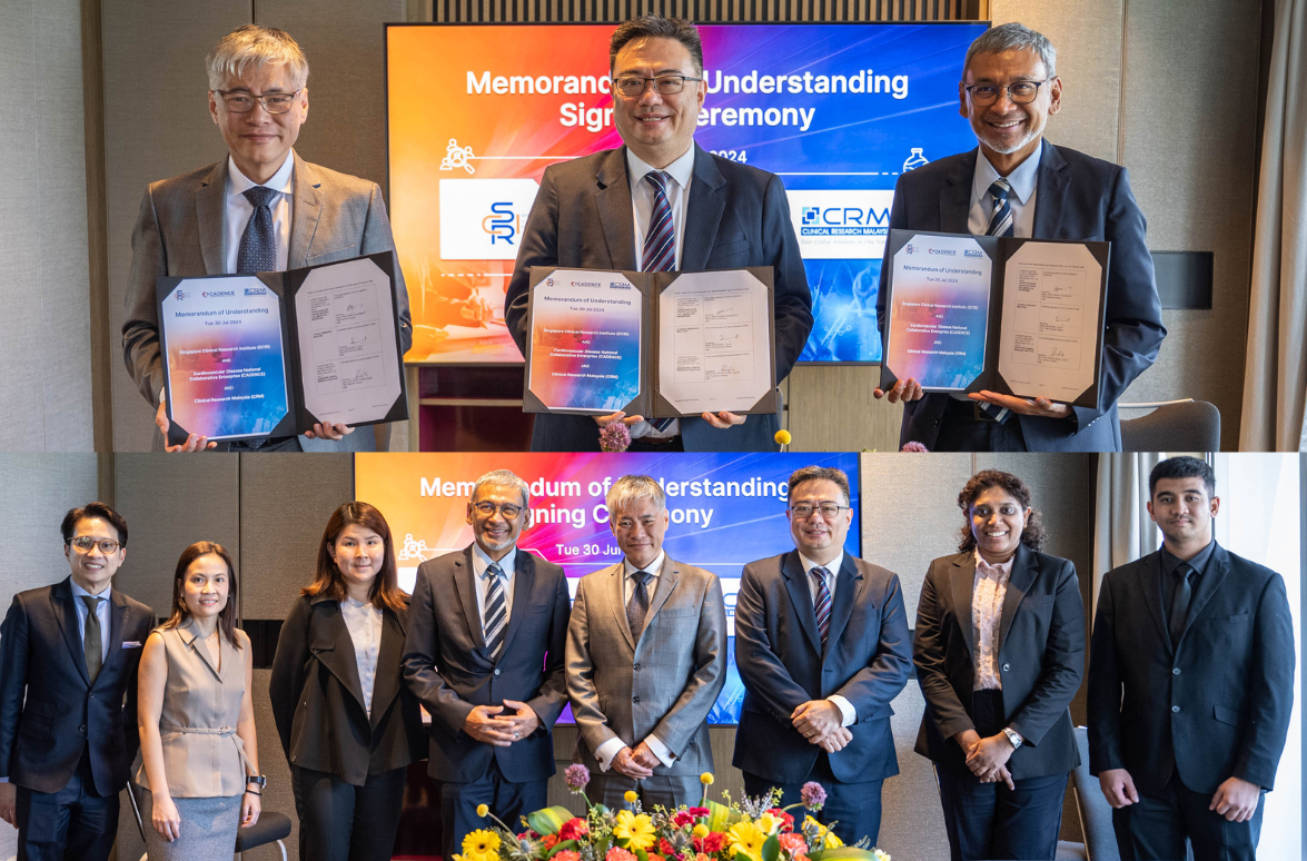 Several individuals in business attire hold documents and pose in front of a screen displaying "Memorandum of Understanding."